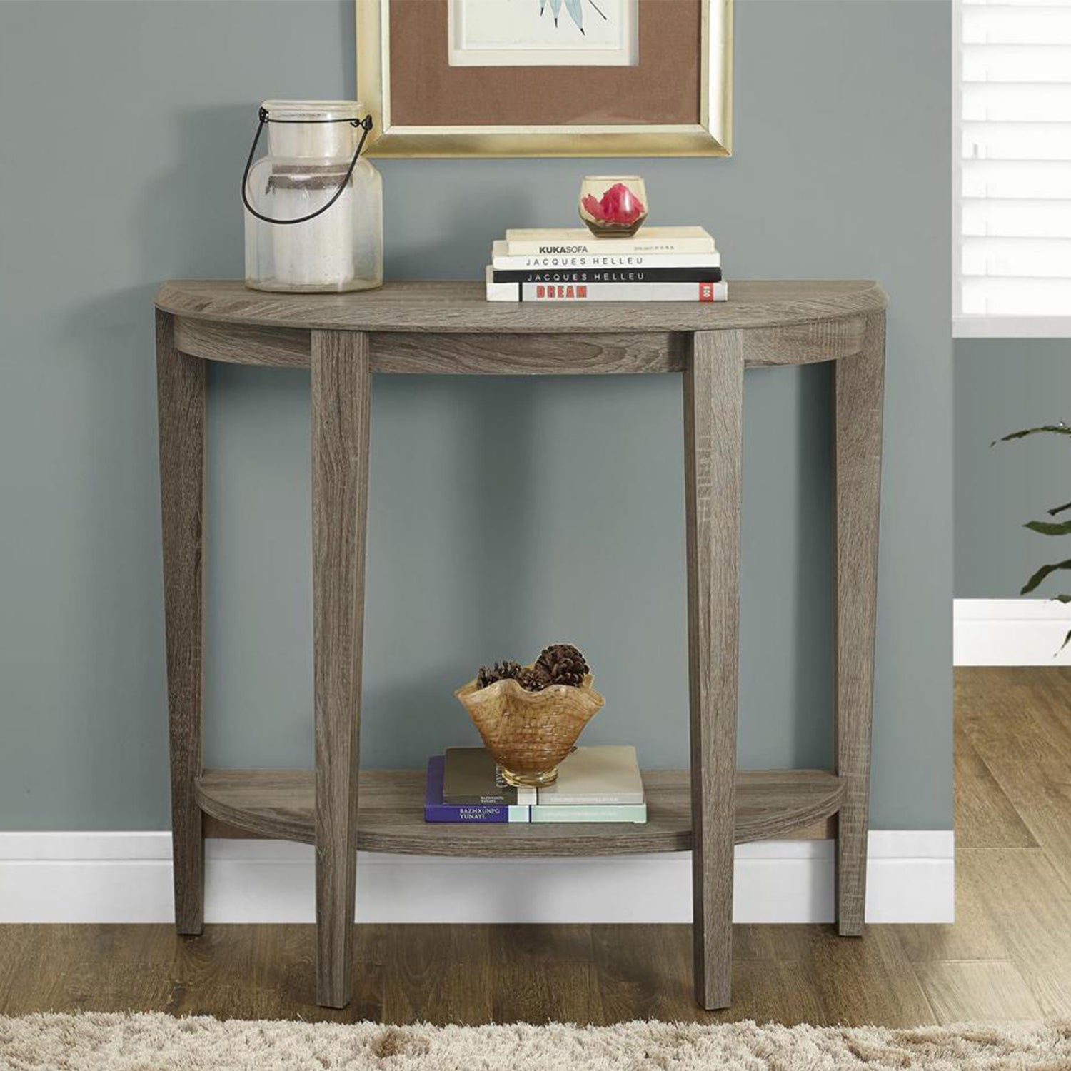 Dark taupe finish accent table with curved half-moon shape and tapered legs, perfect for living spaces.