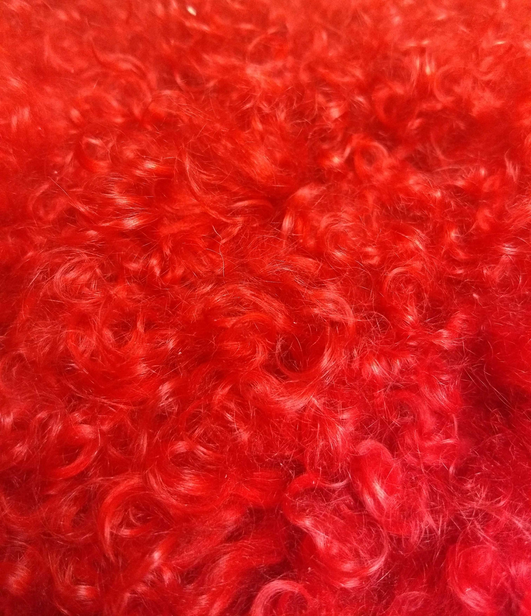 17-inch red genuine Tibetan lamb fur pillow with soft microsuede backing, showcasing luxurious texture and vibrant color.