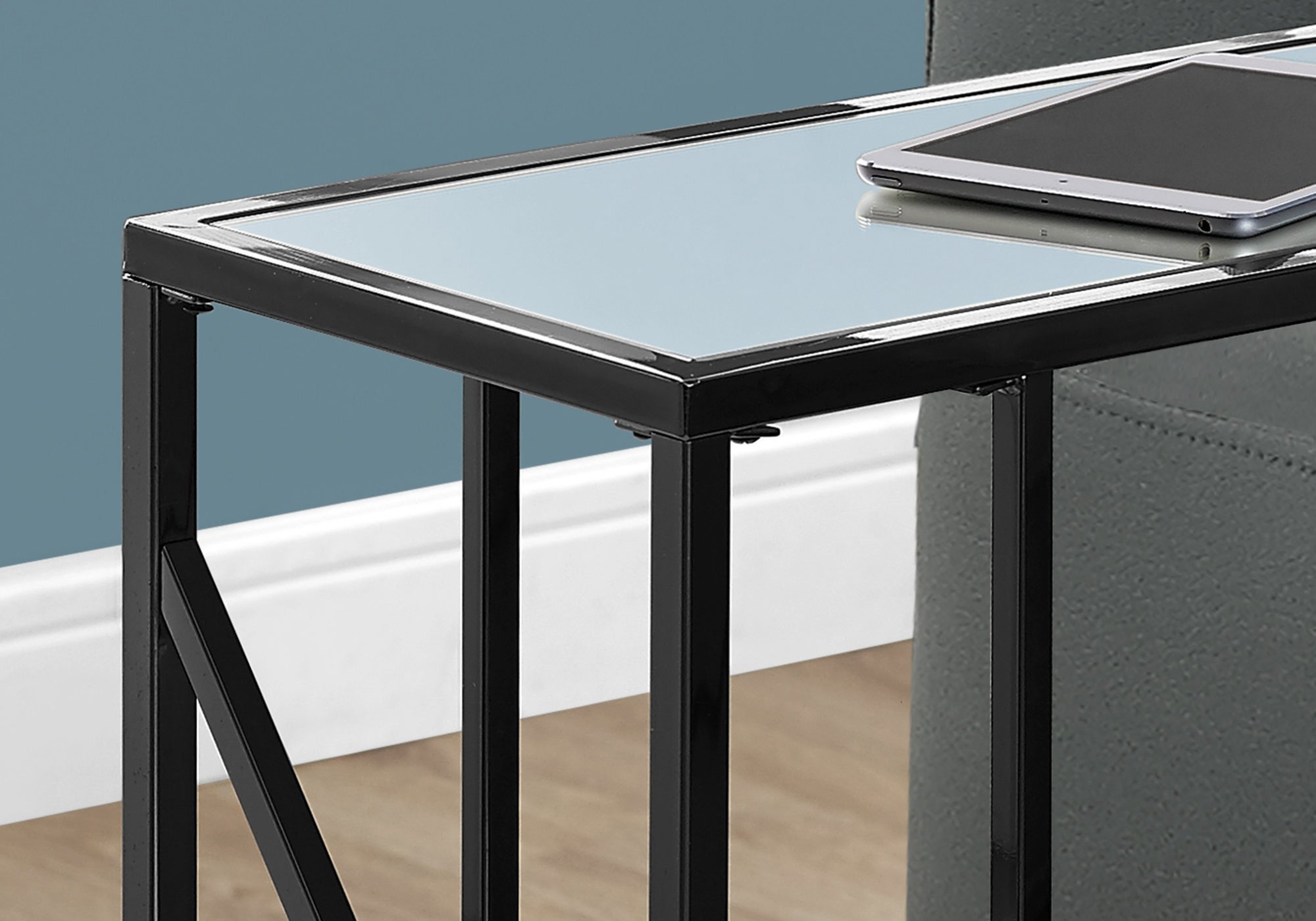 Elegant black metal and glass accent table with particle board, perfect for living room decor.