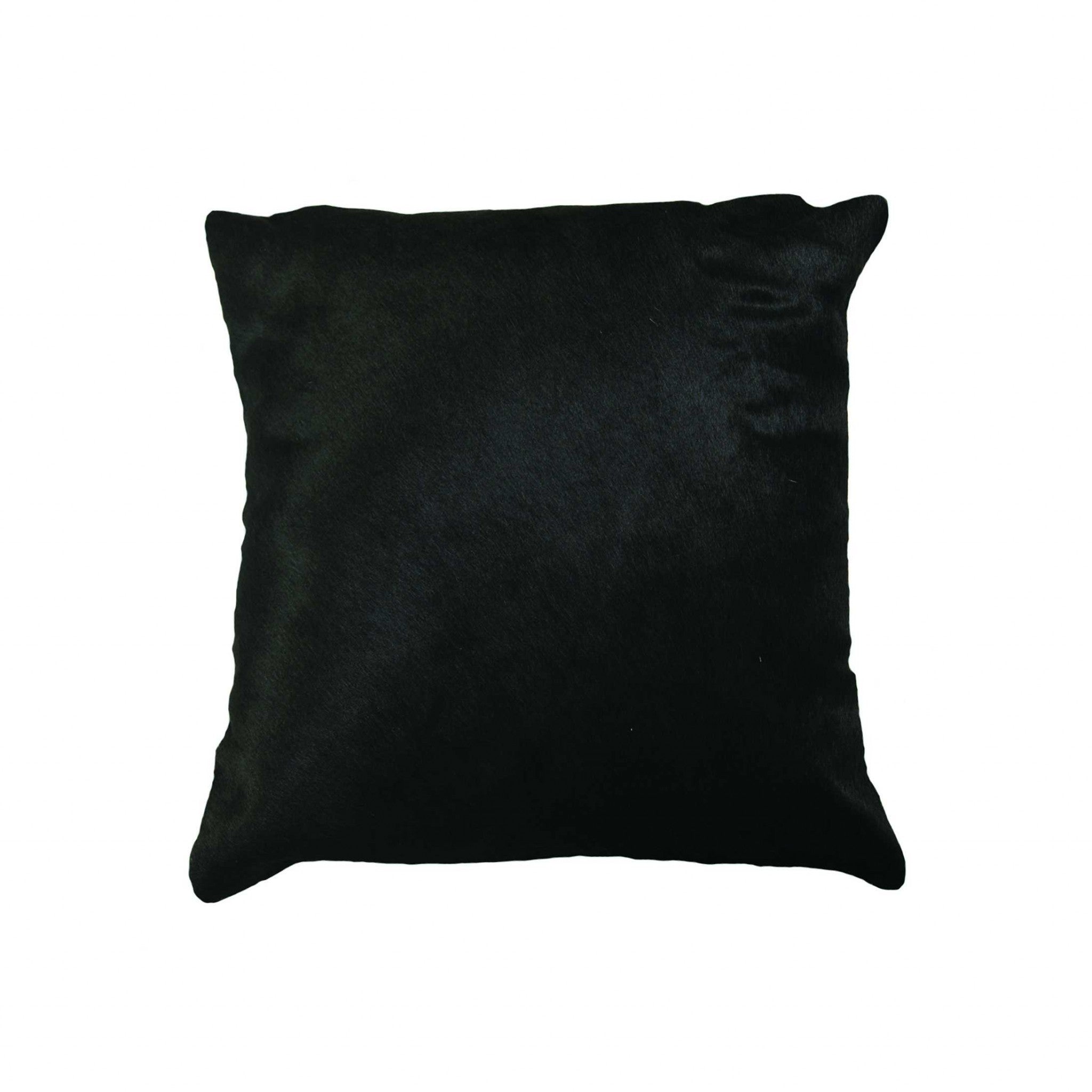 Luxurious 18x18 black cowhide pillow with unique mottling and soft microsuede backing, featuring a hidden zipper closure.