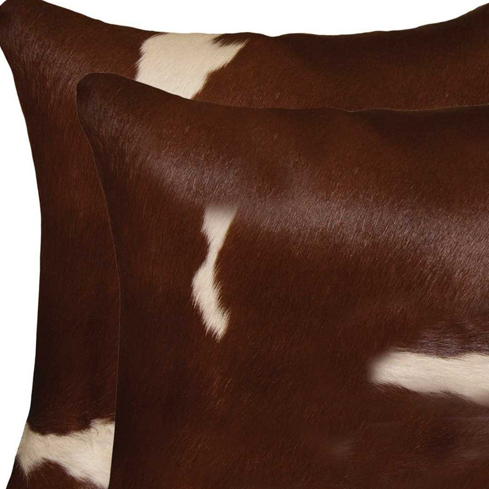 Luxurious 18x18 Gold and Chocolate Quattro Pillow set made from 100% Indian cowhide, featuring a hidden zipper and soft microsuede backing.