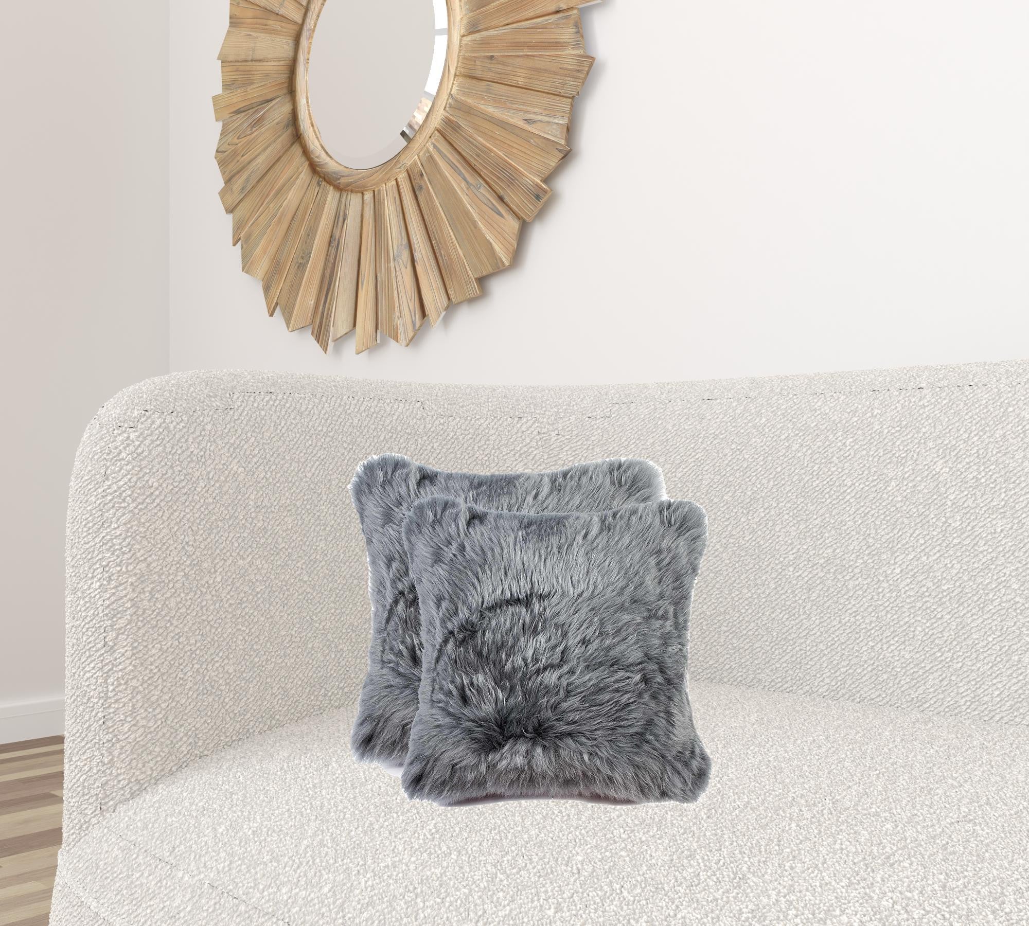 Two luxurious gray sheepskin pillows measuring 18x18 inches with soft microsuede backing, showcasing plush texture and hidden zipper closure.