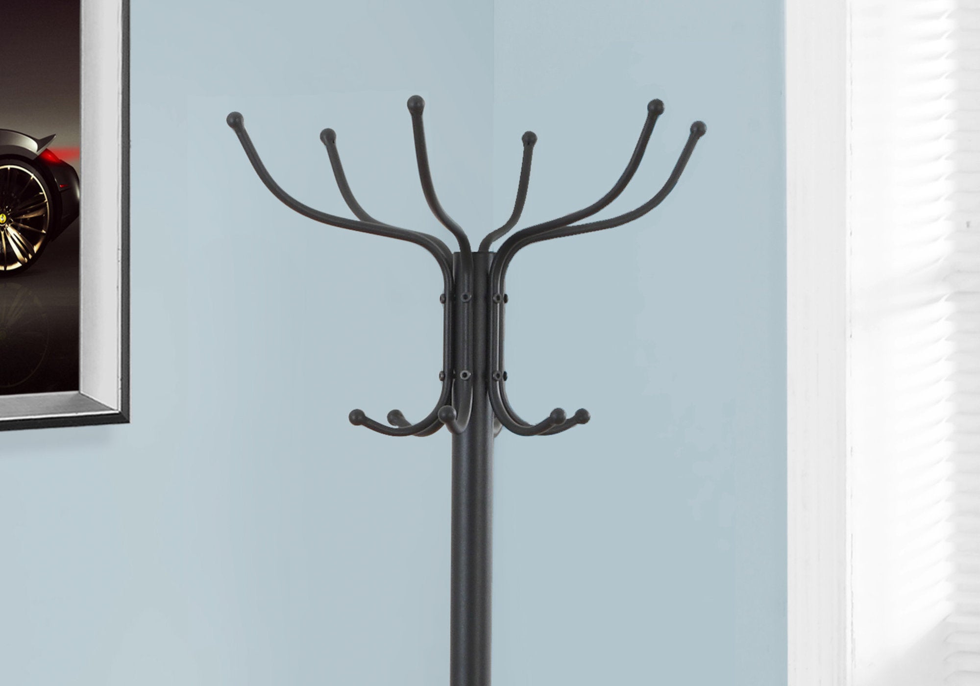 A stylish black metal coat rack standing 70 inches tall with multiple hanging pegs and an umbrella holder, perfect for entryways and hallways.