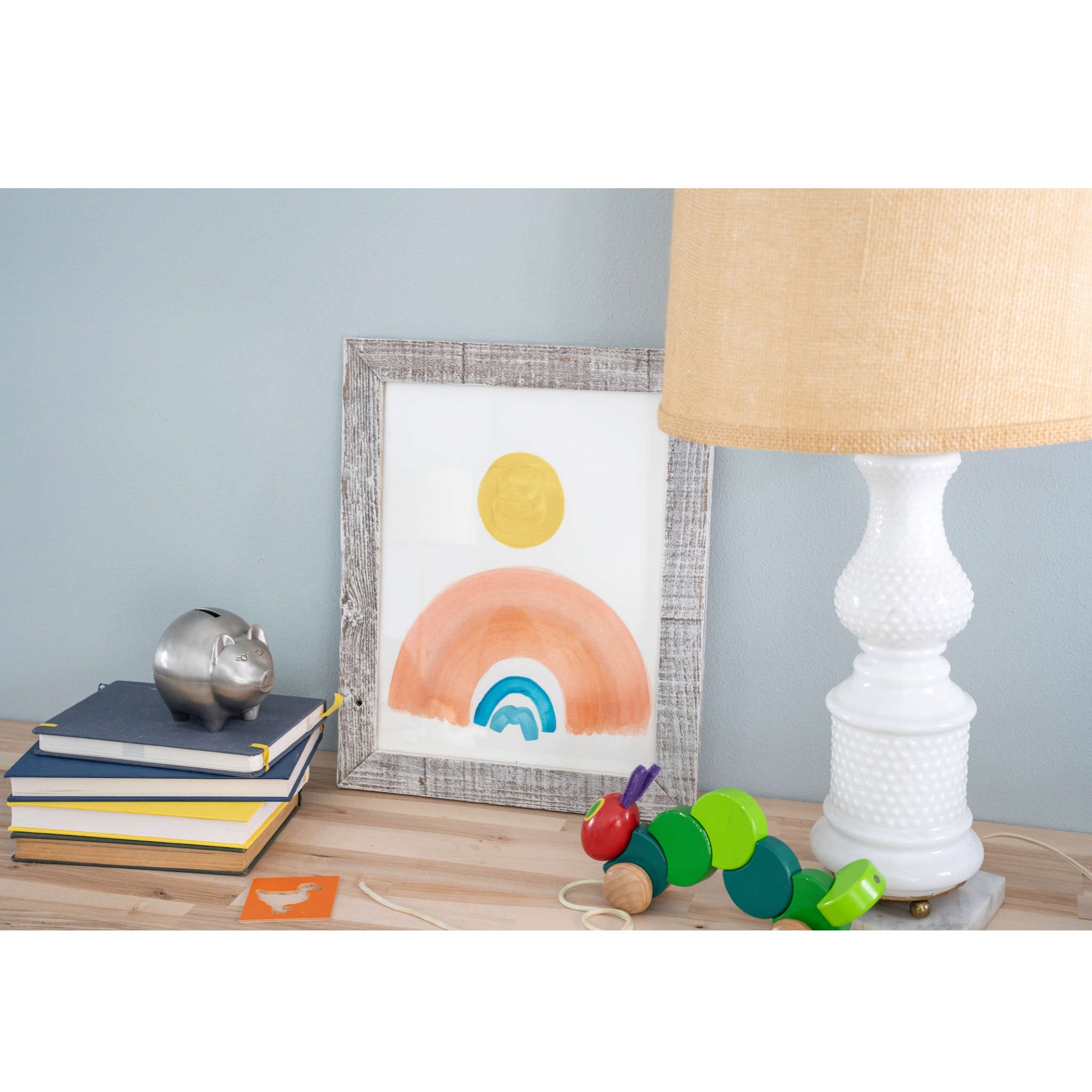 A rustic white washed picture frame holding an 11x14 photo, made from reclaimed wood with a plexiglass holder.