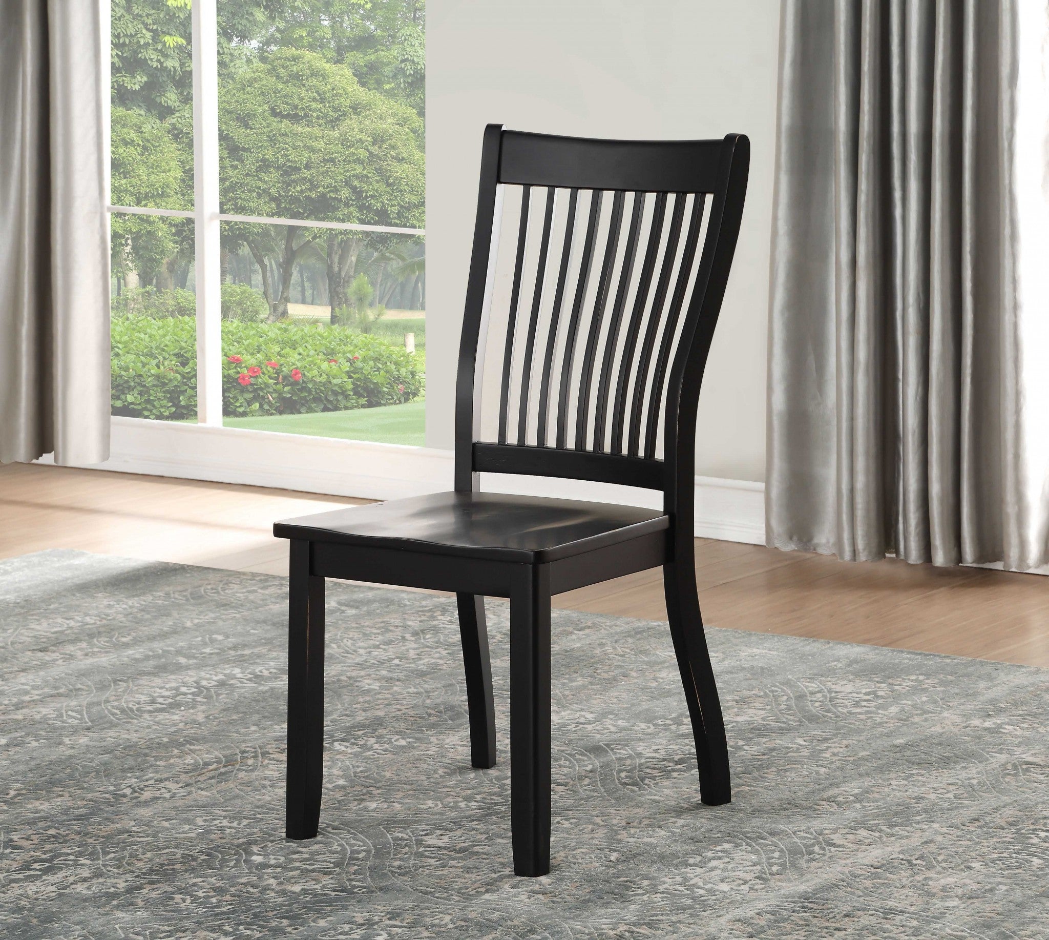 Set of two black side chairs with slatted backrest and tapered legs, crafted from solid wood for durability and style.