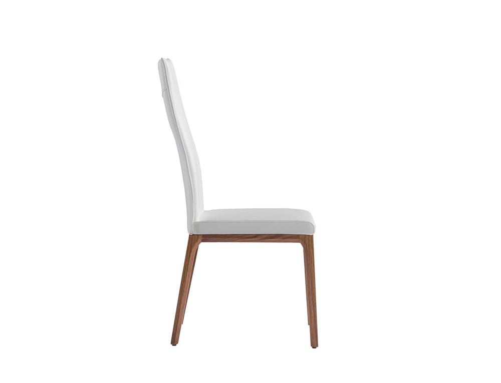 Stylish 20" X 25" X 43" white faux leather dining chair with metal frame, perfect for modern interiors.