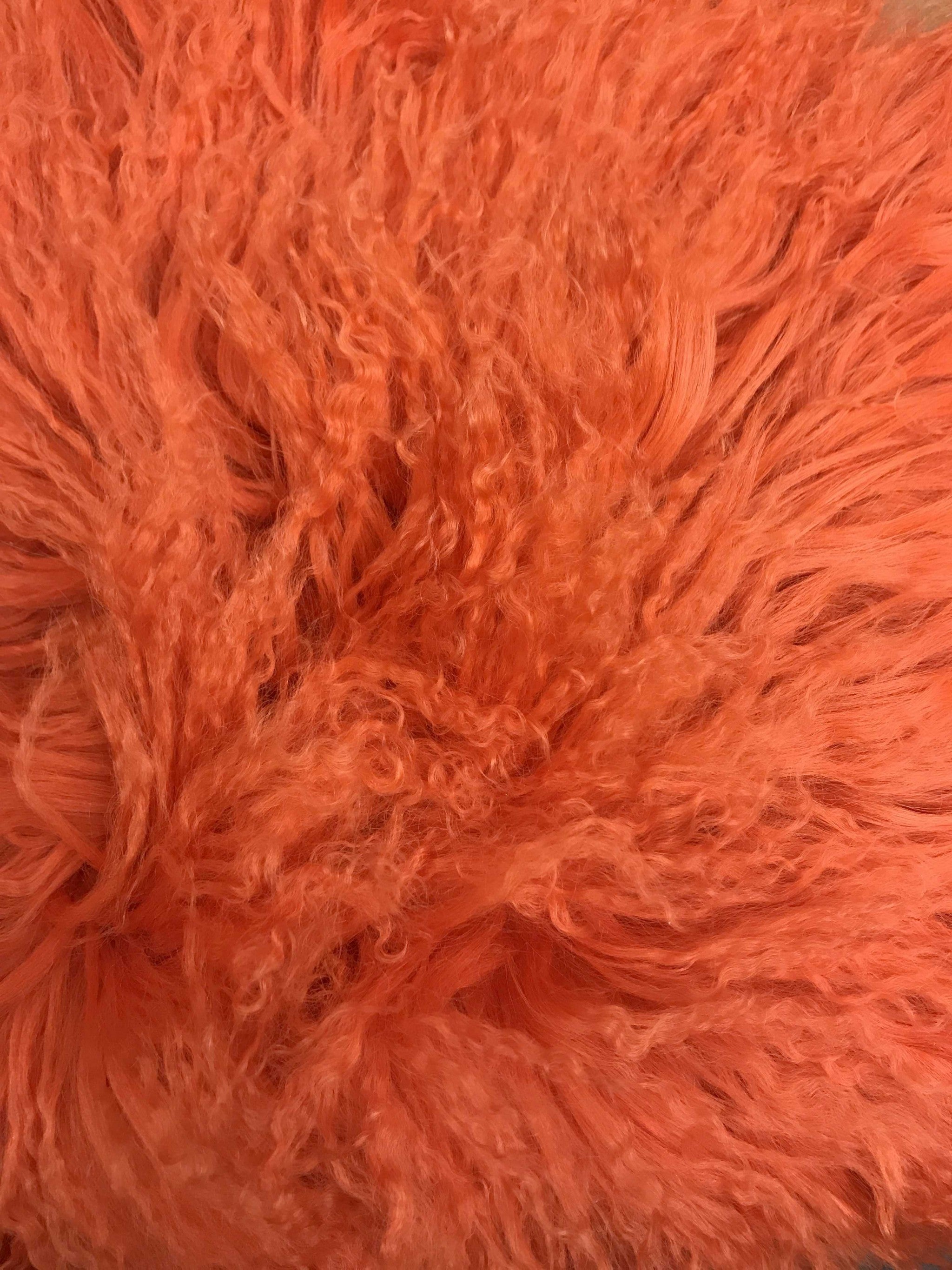 20-inch orange genuine Tibetan lamb fur pillow with soft microsuede backing, showcasing luxurious texture and vibrant color.