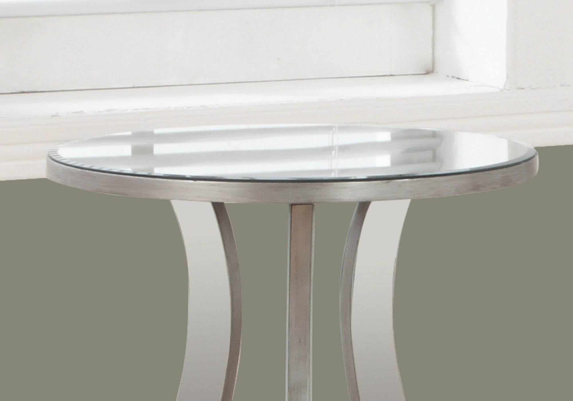 A stylish silver end table with a mirrored top, measuring 20x20x24 inches, perfect for living room decor.