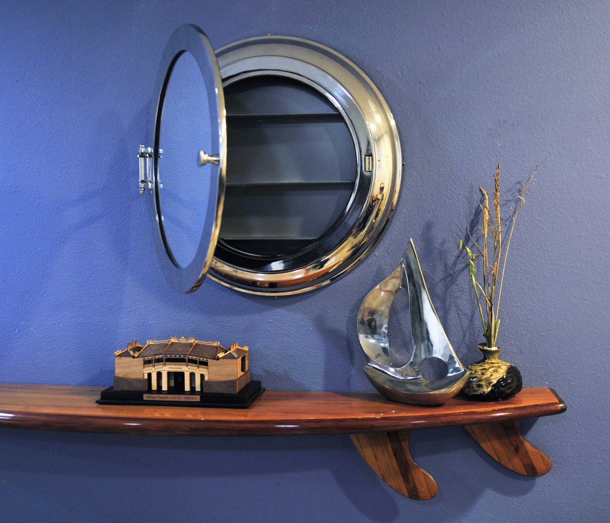 A stylish 21x21 inches aluminum wall mirror with a vintage porthole design, featuring a hinged storage compartment and a sleek nickel finish.