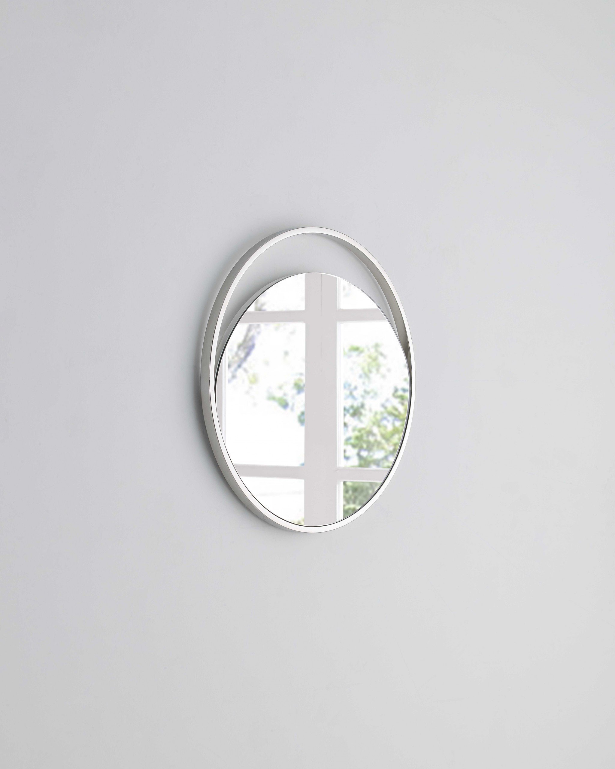 A stylish 23-inch round white glass mirror with a matte finish and durable aluminum frame, perfect for modern home decor.