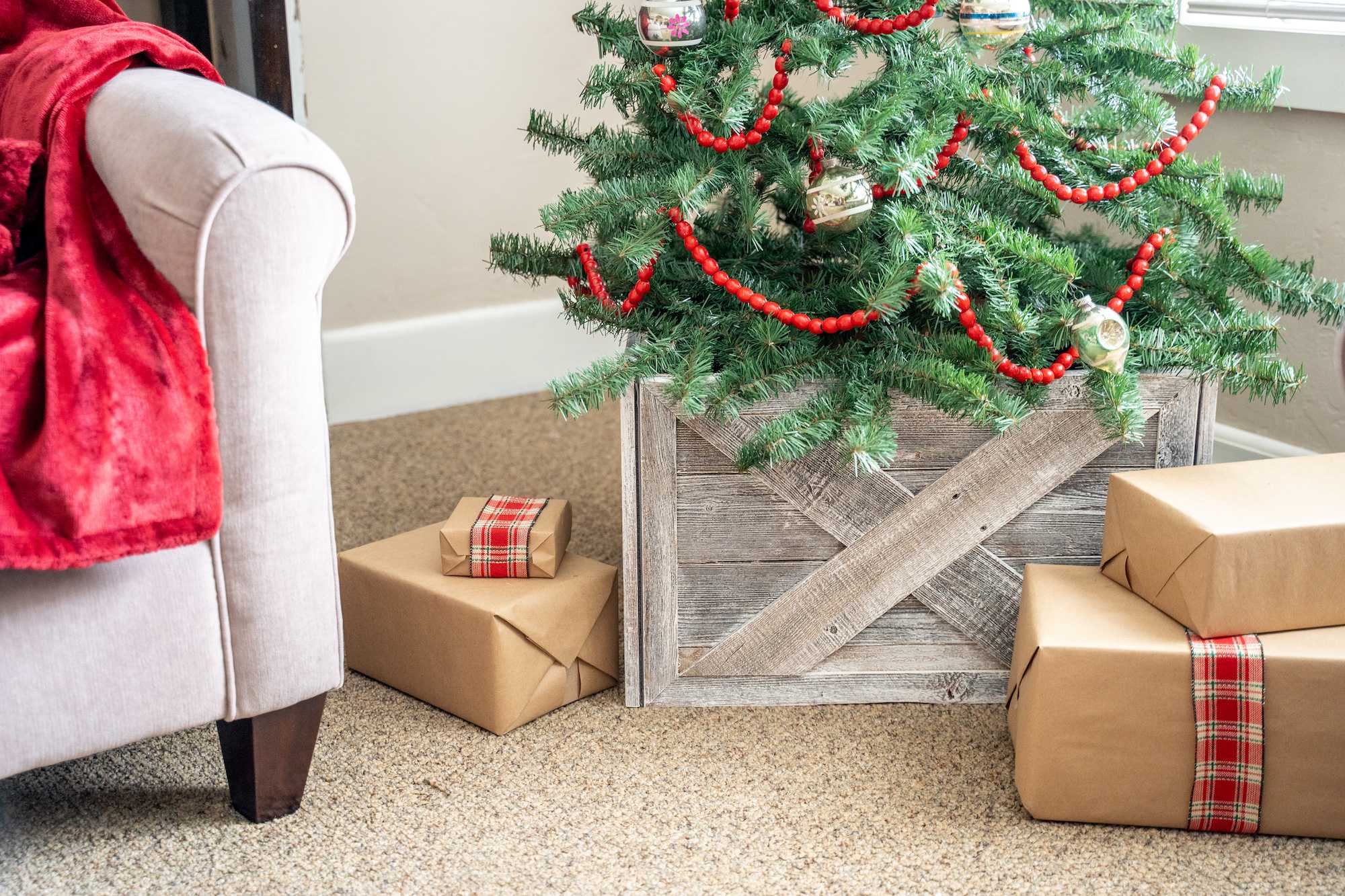 23-inch Natural Weathered Gray Whitewash Christmas Tree Collar featuring rustic X design, made from reclaimed wood, enhancing holiday decor.