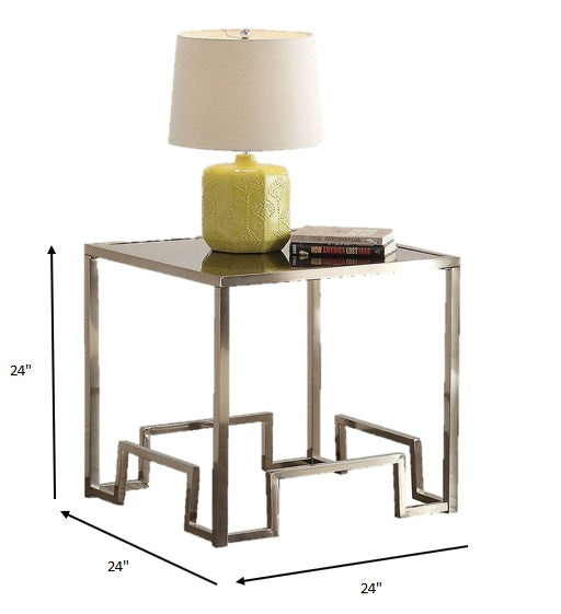 A luxurious 24x24x24 inches champagne and clear glass end table featuring a geometric metal base and a clear tempered glass top.