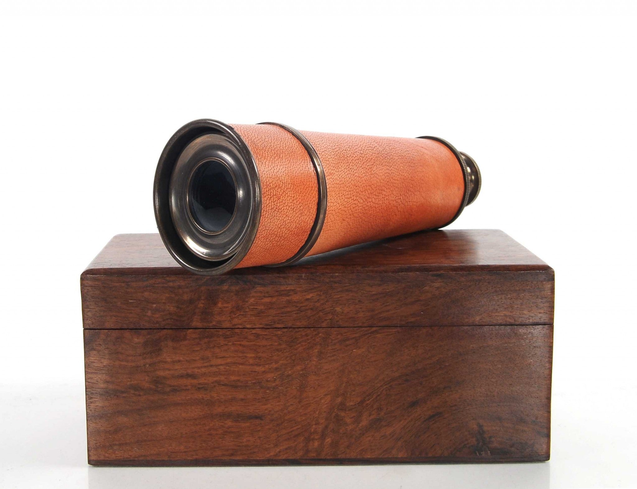 A beautifully crafted handheld telescope made of brass, featuring an antique leather overlay, displayed in an elegant rosewood gift box.