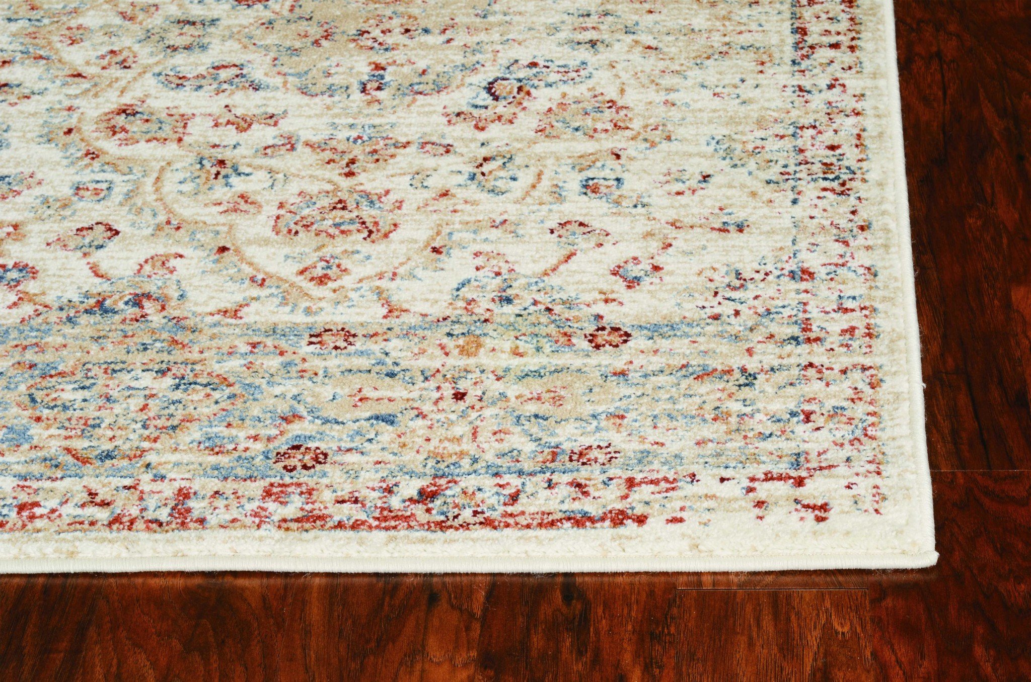 A plush 26" x 90" ivory polypropylene rug featuring vintage patterns, perfect for enhancing home decor.