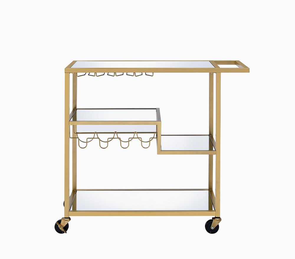 Elegant gold and clear glass serving cart with three shelves and caster wheels, perfect for serving meals and drinks.