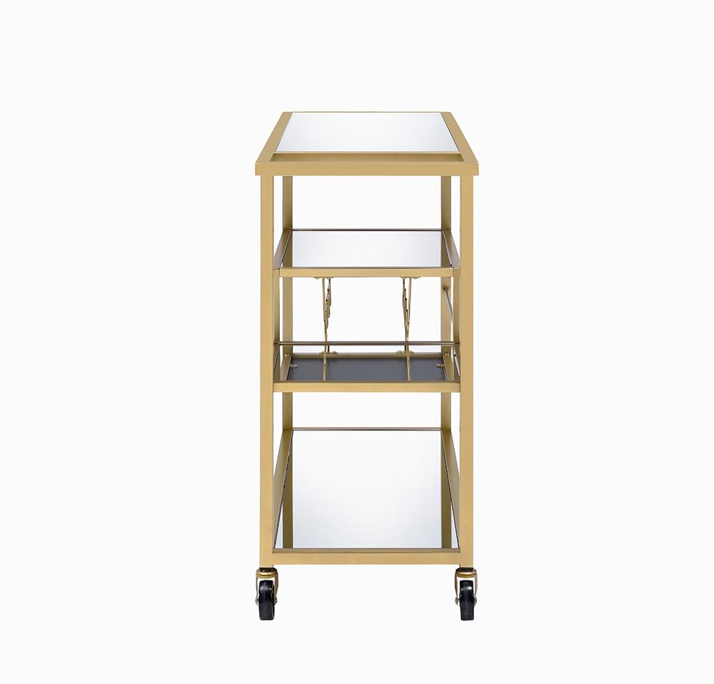 Elegant gold and clear glass serving cart with three shelves and caster wheels, perfect for serving meals and drinks.