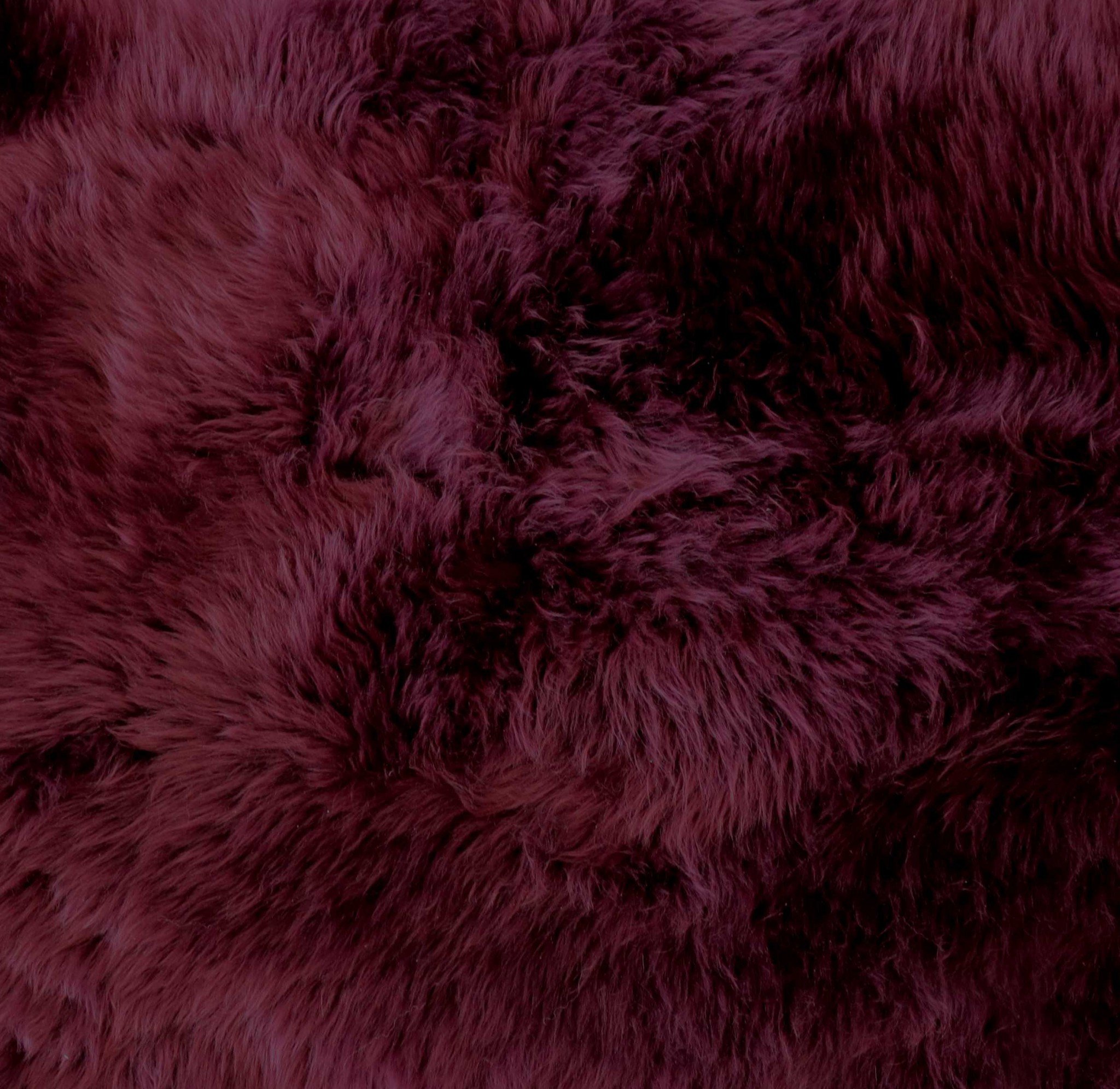 A luxurious 2x3 burgundy New Zealand natural sheepskin rug showcasing its rich texture and color, perfect for home decor.