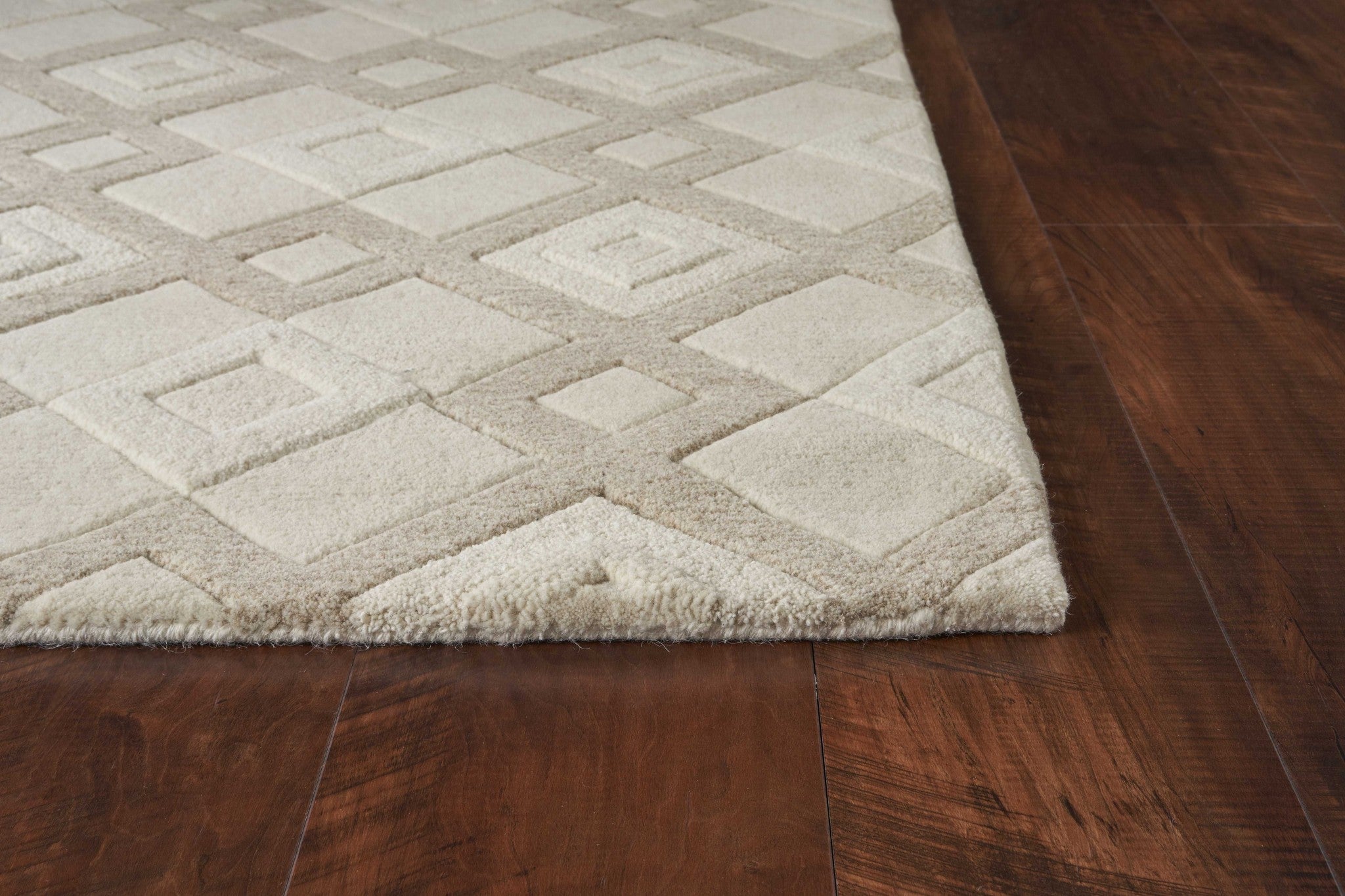 A luxurious 2x4 ivory diamond wool area rug showcasing a contemporary design with a soft texture, perfect for enhancing home decor.