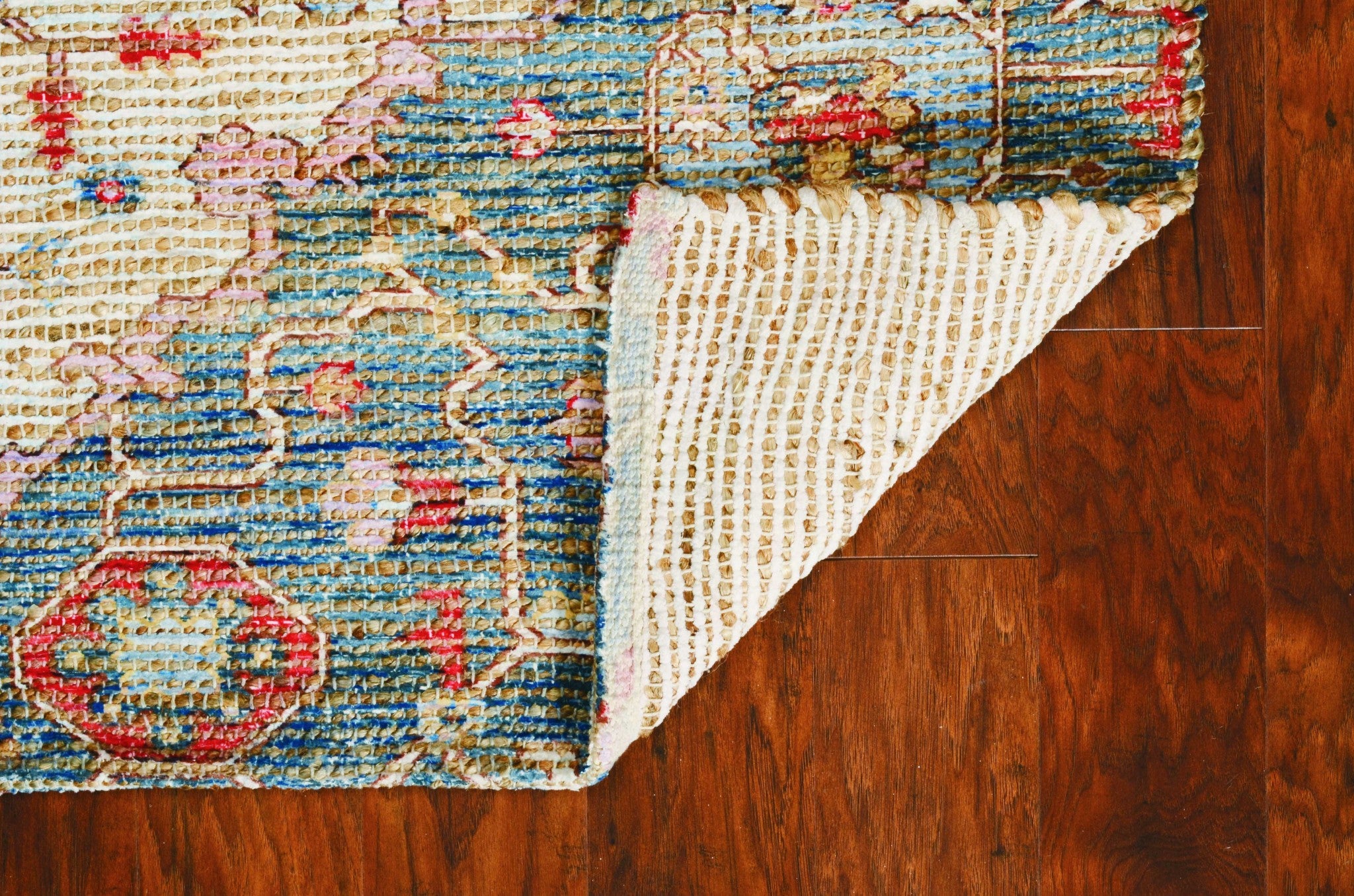 A vibrant 2x4 inches jute area rug in blue and red, hand-woven with no backing, showcasing contemporary design and traditional craftsmanship.