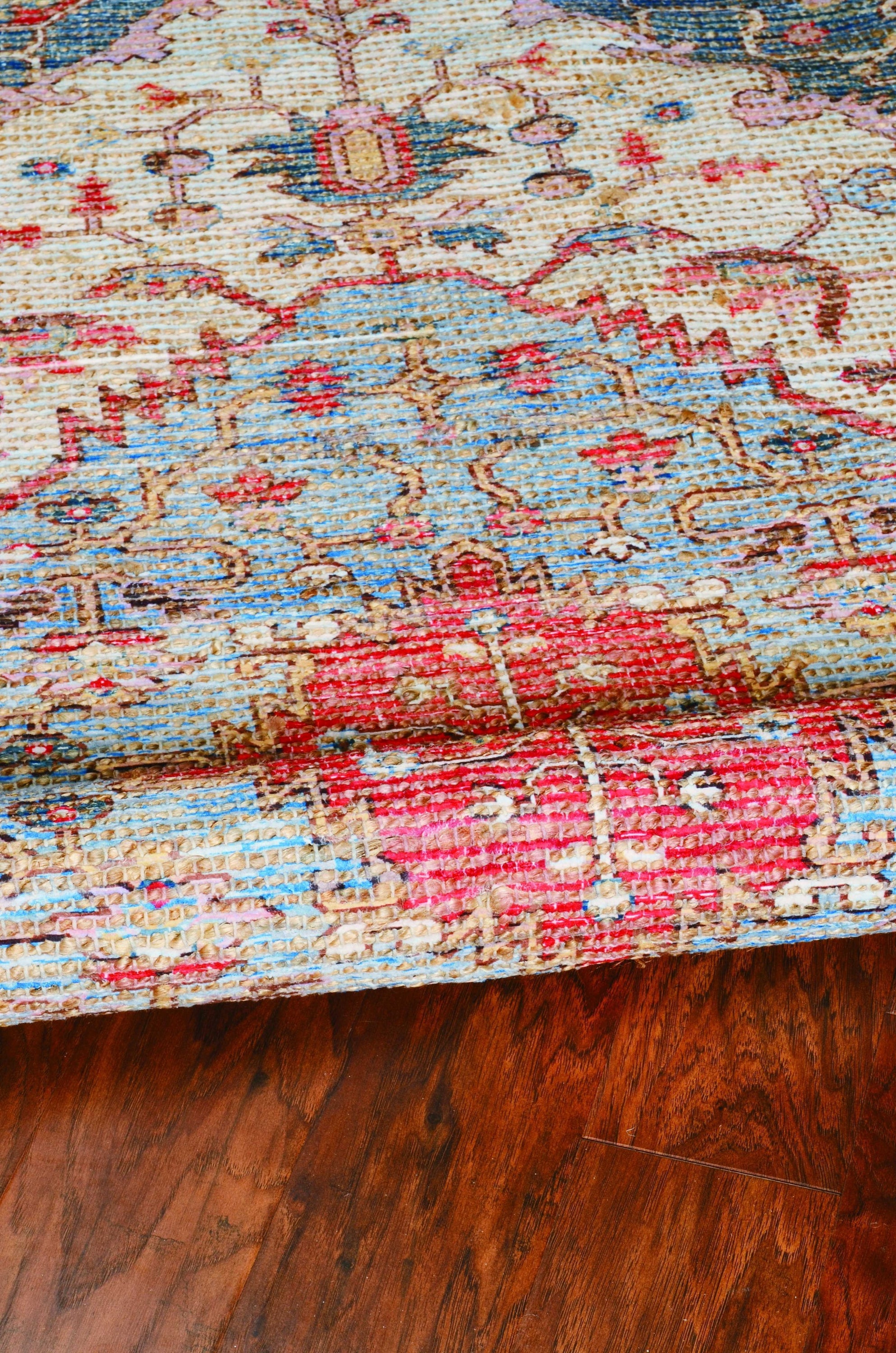 A vibrant 2x4 inches jute area rug in blue and red, hand-woven with no backing, showcasing contemporary design and traditional craftsmanship.