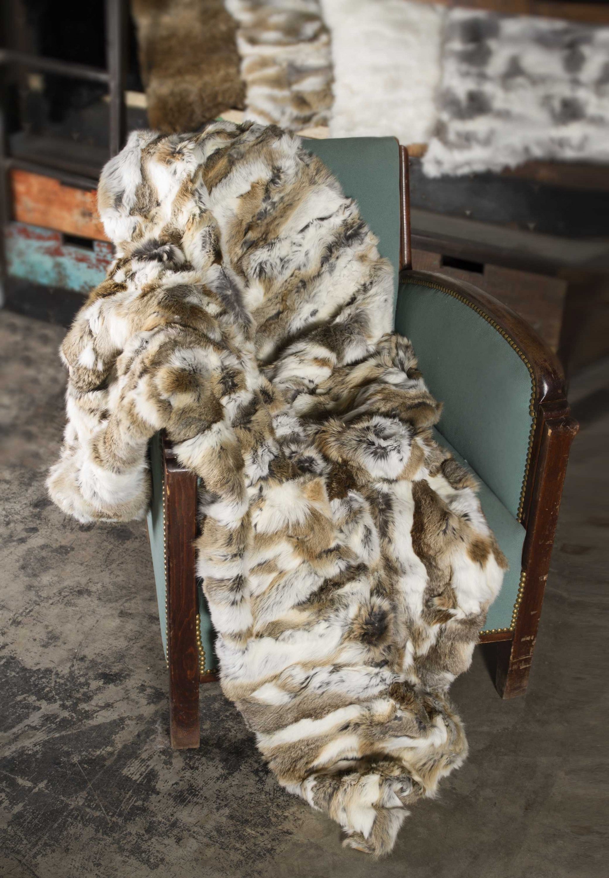 Luxurious 100% natural rabbit fur blanket in tan and white, showcasing its plush texture and elegant design.