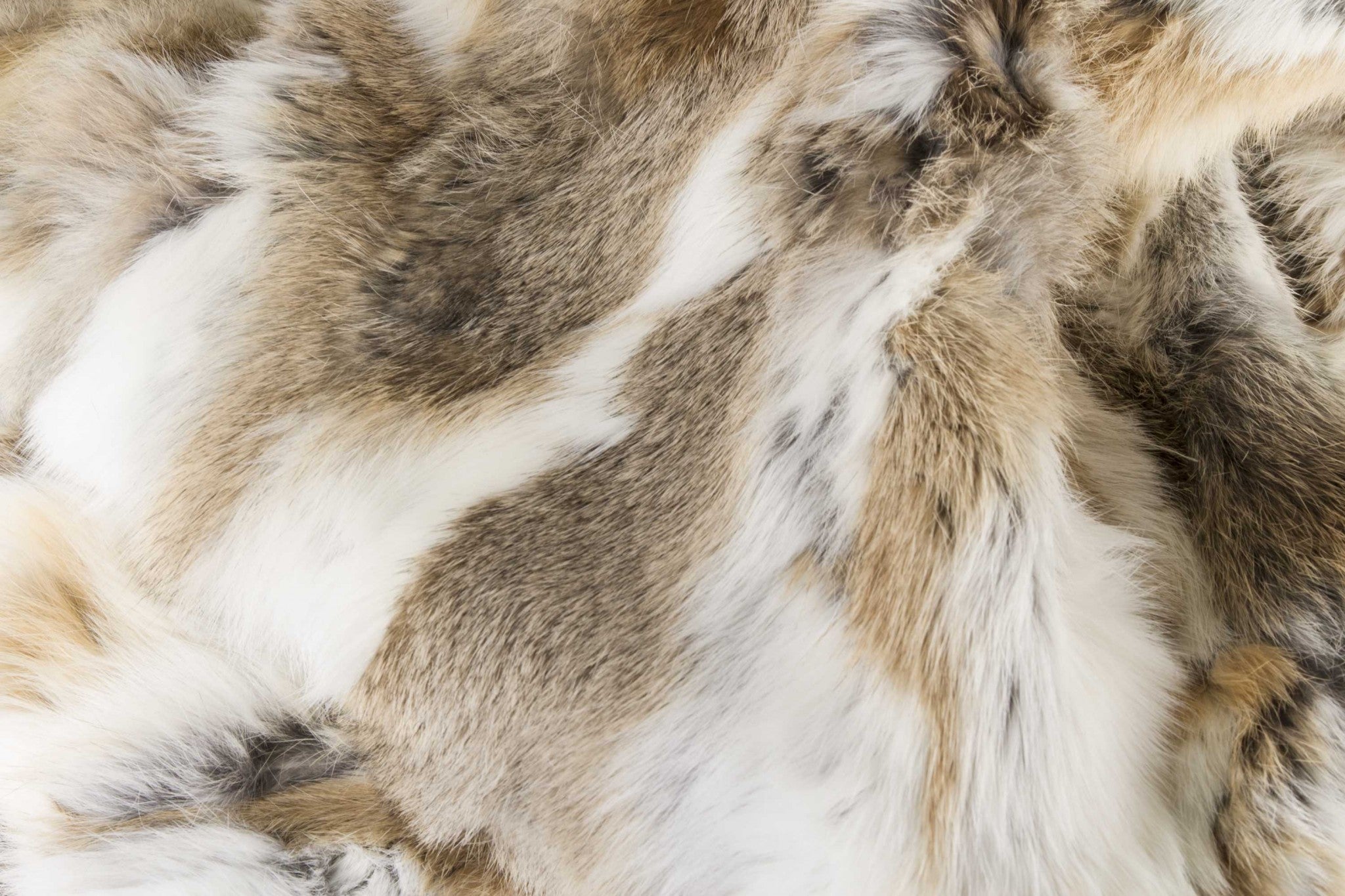 Luxurious 100% natural rabbit fur blanket in tan and white, showcasing its plush texture and elegant design.