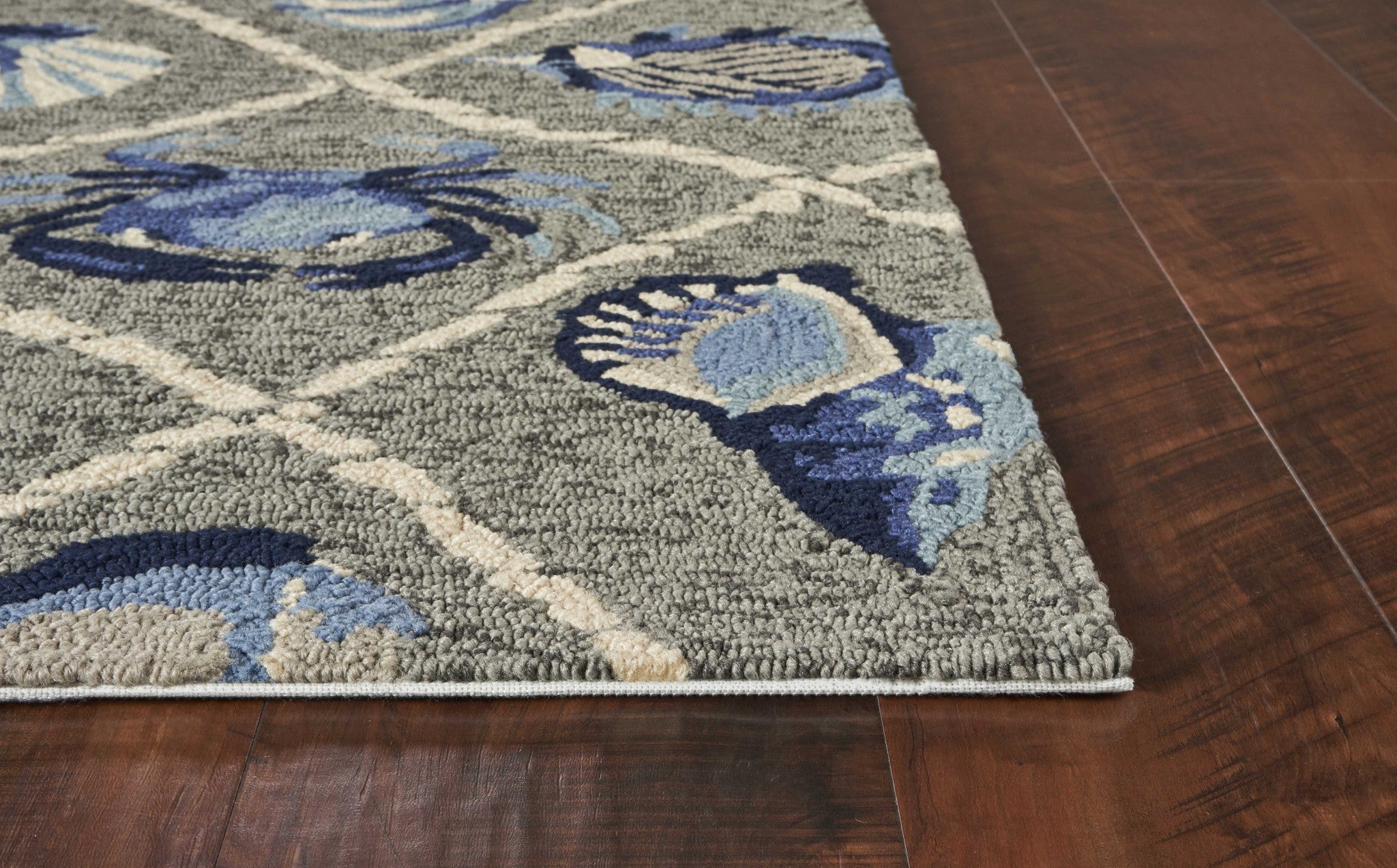 A 2x3 inches grey hand-hooked rug featuring coastal sea life designs, suitable for indoor and outdoor use.