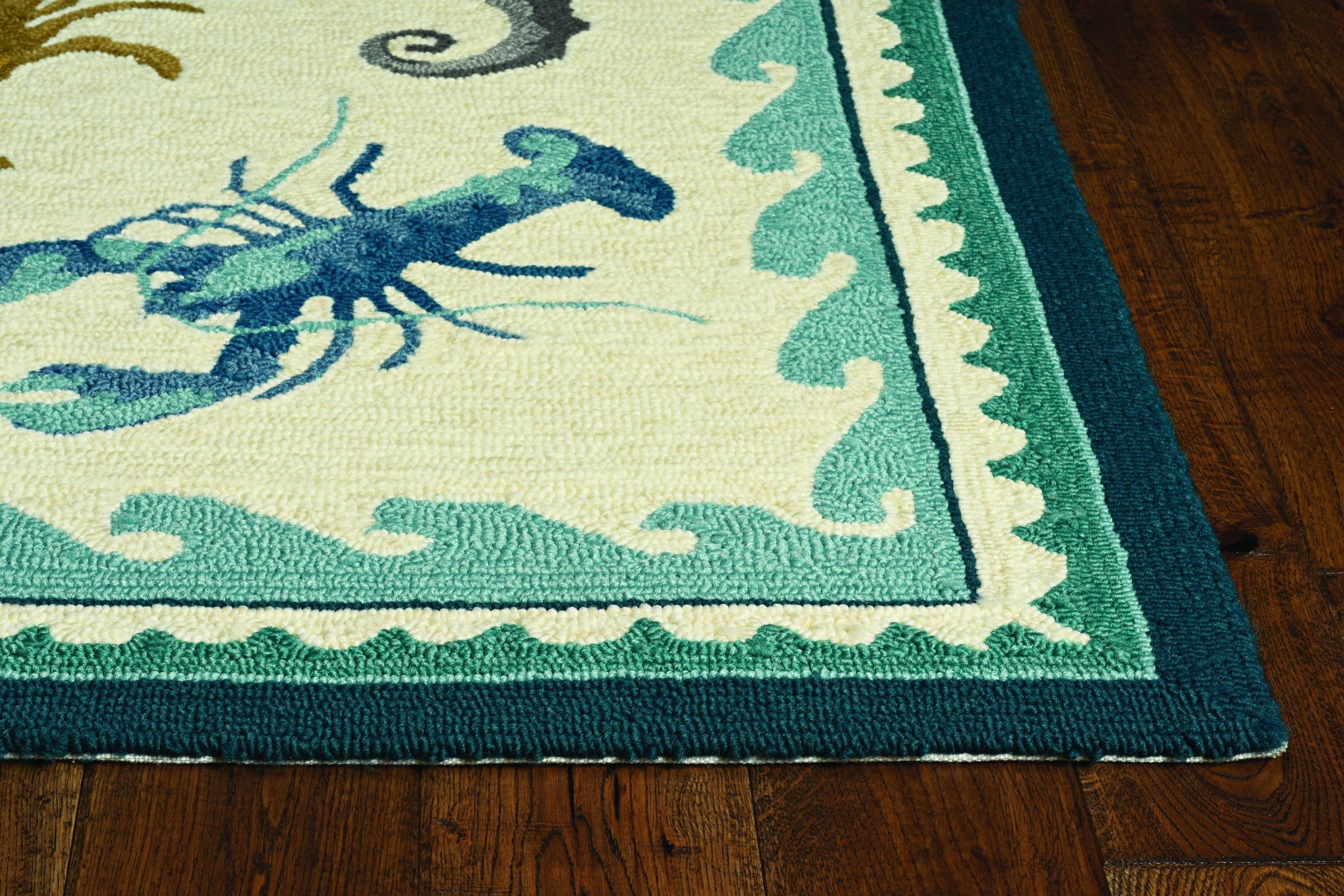 A beautifully crafted 2x3 inches ivory teal hand-hooked rug featuring a coastal sea design, perfect for indoor and outdoor use.