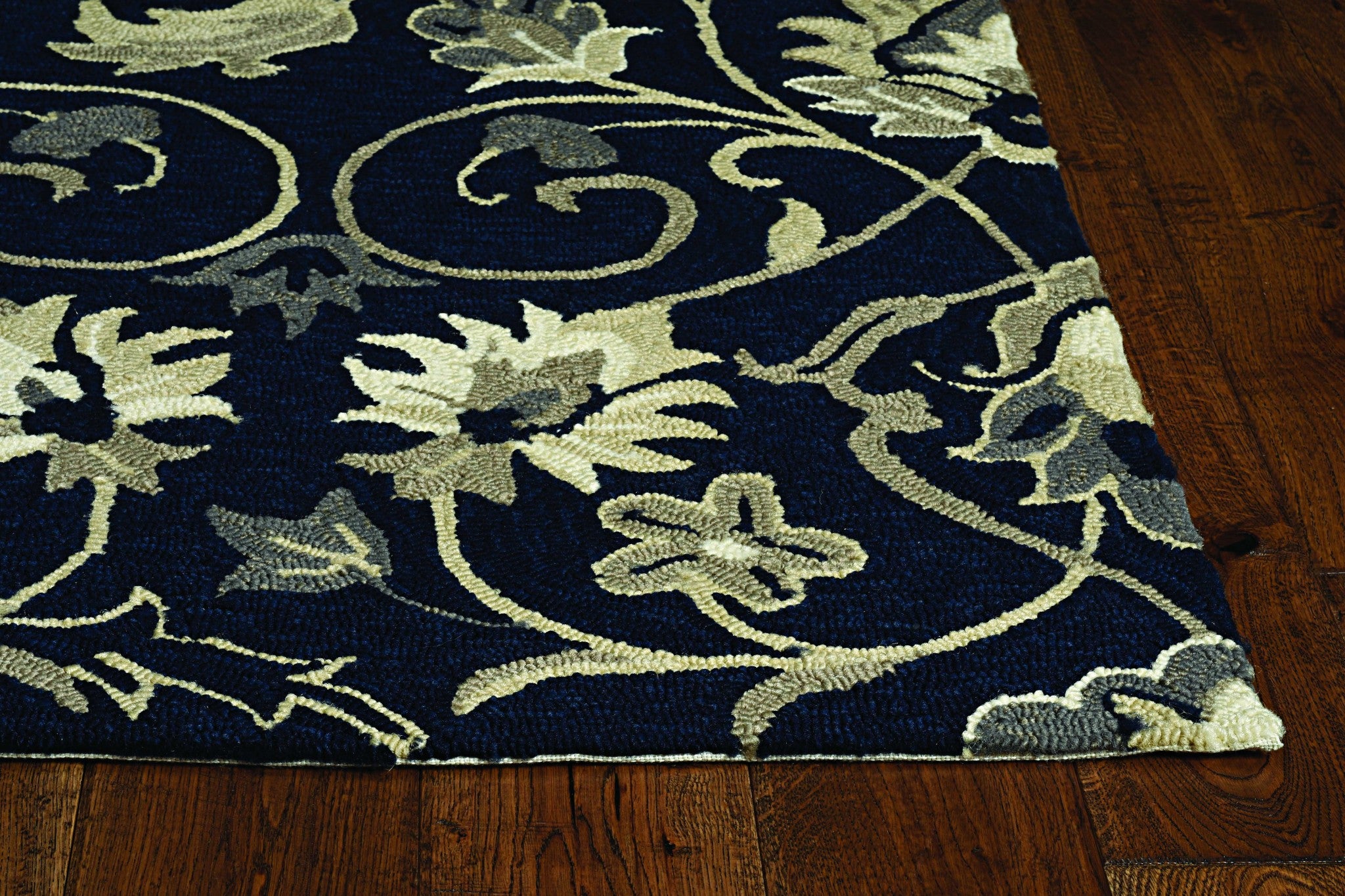 Navy blue hand hooked rug featuring floral vines design, suitable for indoor and outdoor use.