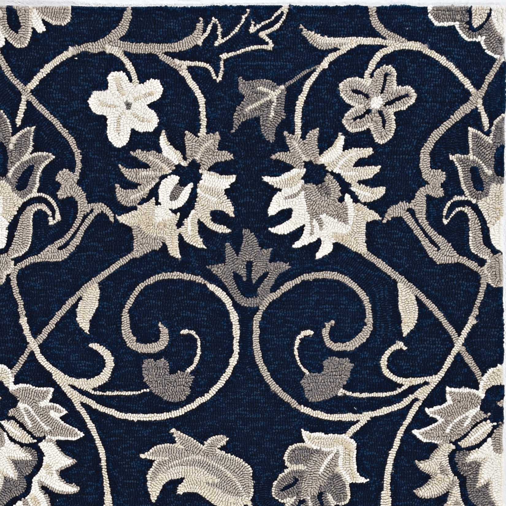 Navy blue hand hooked rug featuring floral vines design, suitable for indoor and outdoor use.