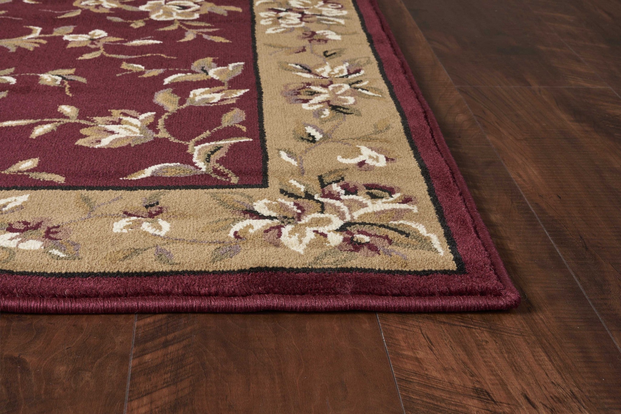 A beautiful red and beige floral traditional indoor rug, measuring 2x3 inches, showcasing intricate patterns and a machine-woven finish.