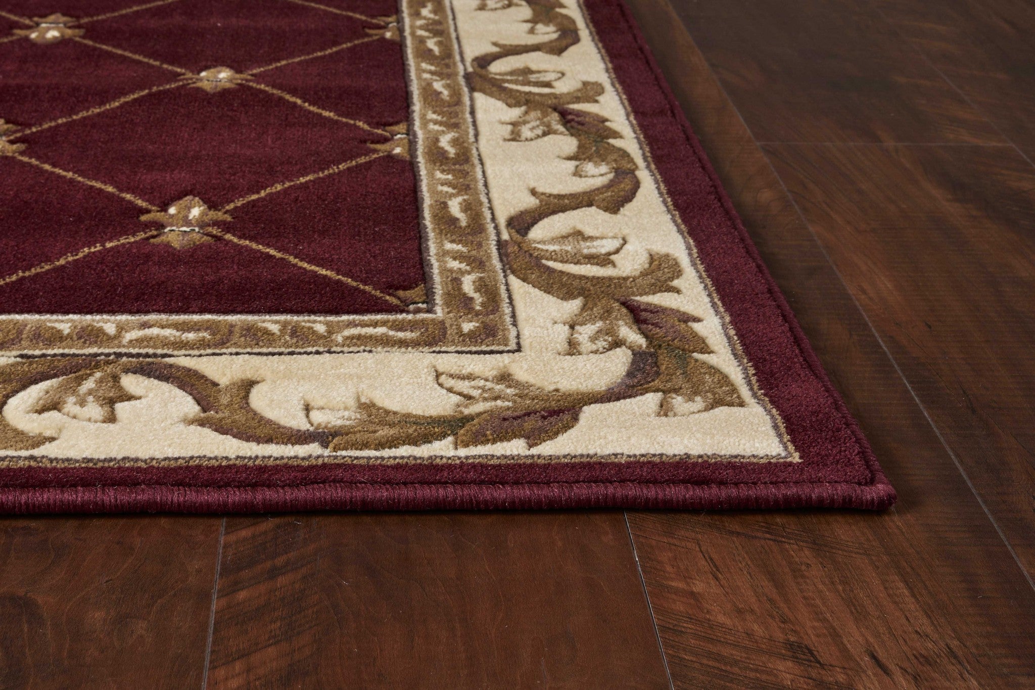 A vibrant red indoor rug featuring a hand-carved fleur-de-lis design, perfect for enhancing home decor.