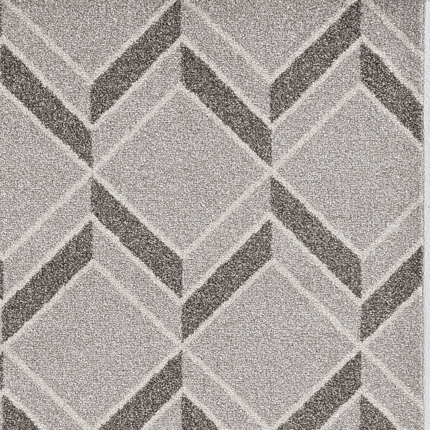 A stylish 2x4 grey herringbone illusion rug, machine woven and UV treated for outdoor durability, displayed on a wooden deck.