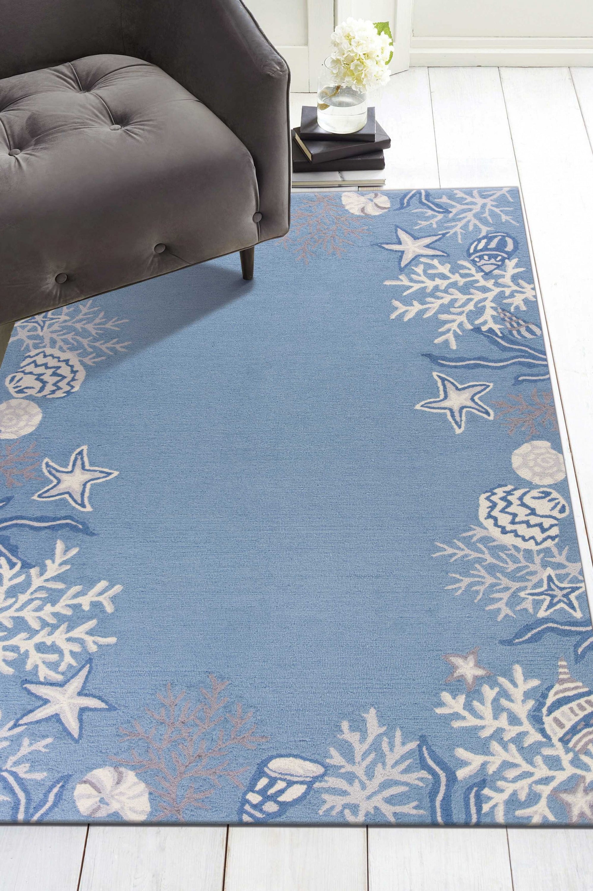 A beautiful sea blue hand hooked rug featuring a bordered coral reef design, perfect for indoor accent decor.