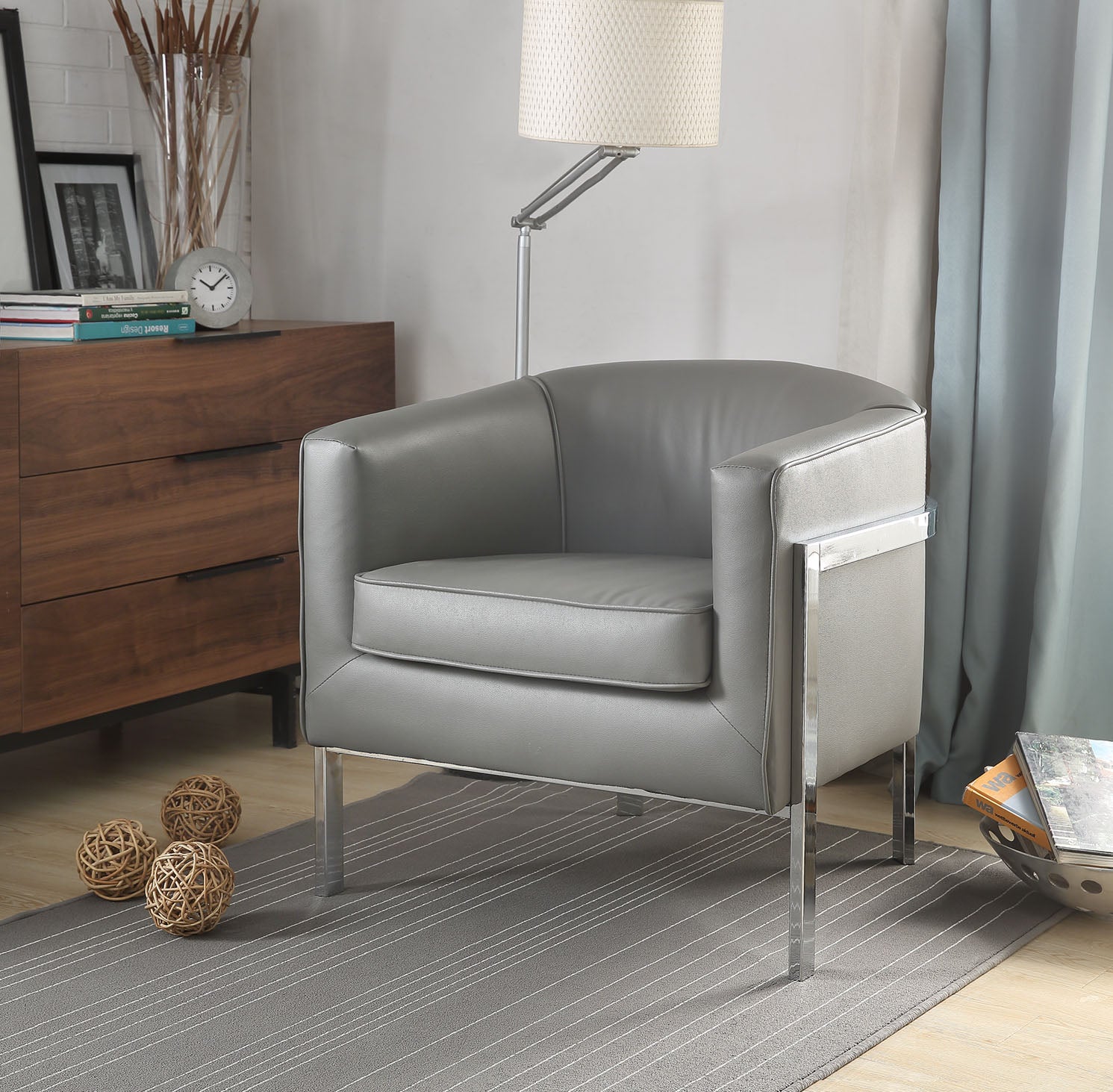 Gray edgy accent chair with chrome metal legs and thick padded seat cushion, designed for modern living spaces.