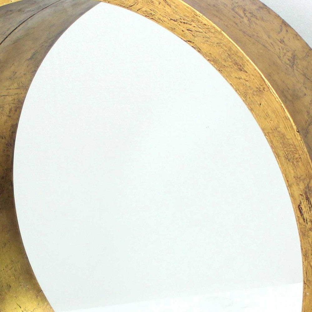 A luxurious gold round tray shaped cosmetic mirror with a wooden frame, showcasing intricate design and a bright gold leaf finish.