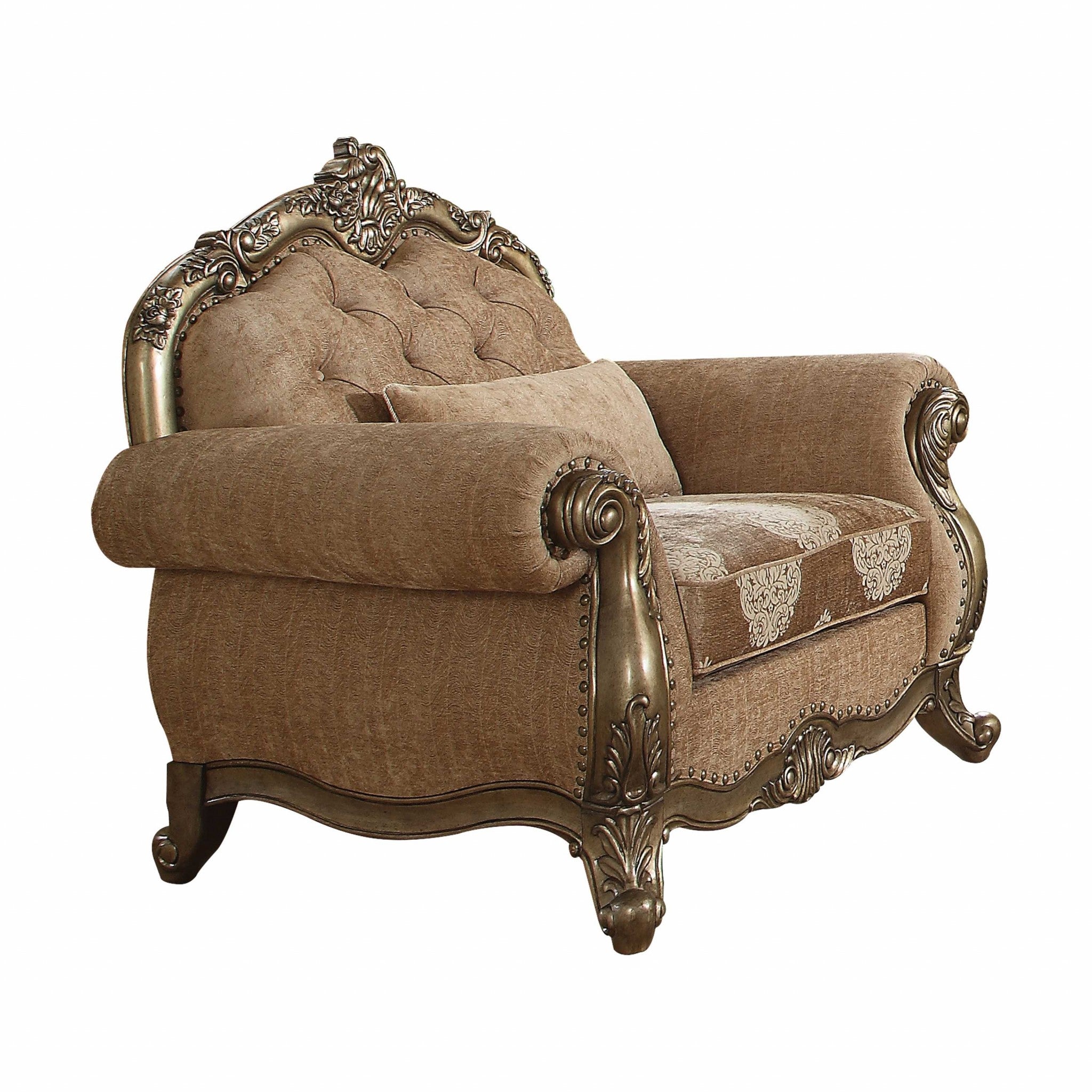 A vintage oak upholstered chair with decorative pillows, featuring a button tufted backrest and ornate trim, perfect for living room decor.