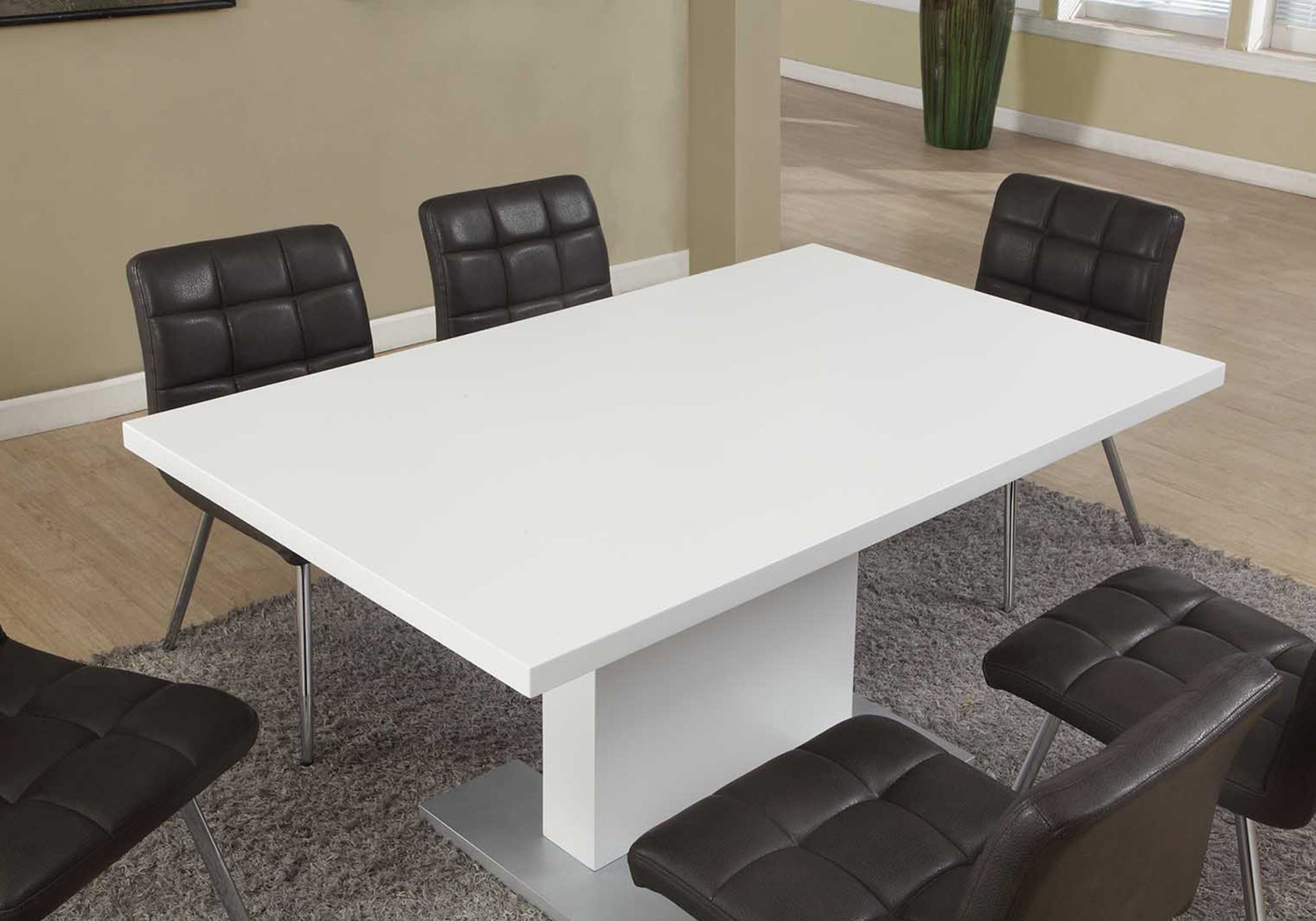 A stylish white metal dining table with a circular design, measuring 35.5 inches wide, 59 inches deep, and 30 inches high, perfect for contemporary interiors.