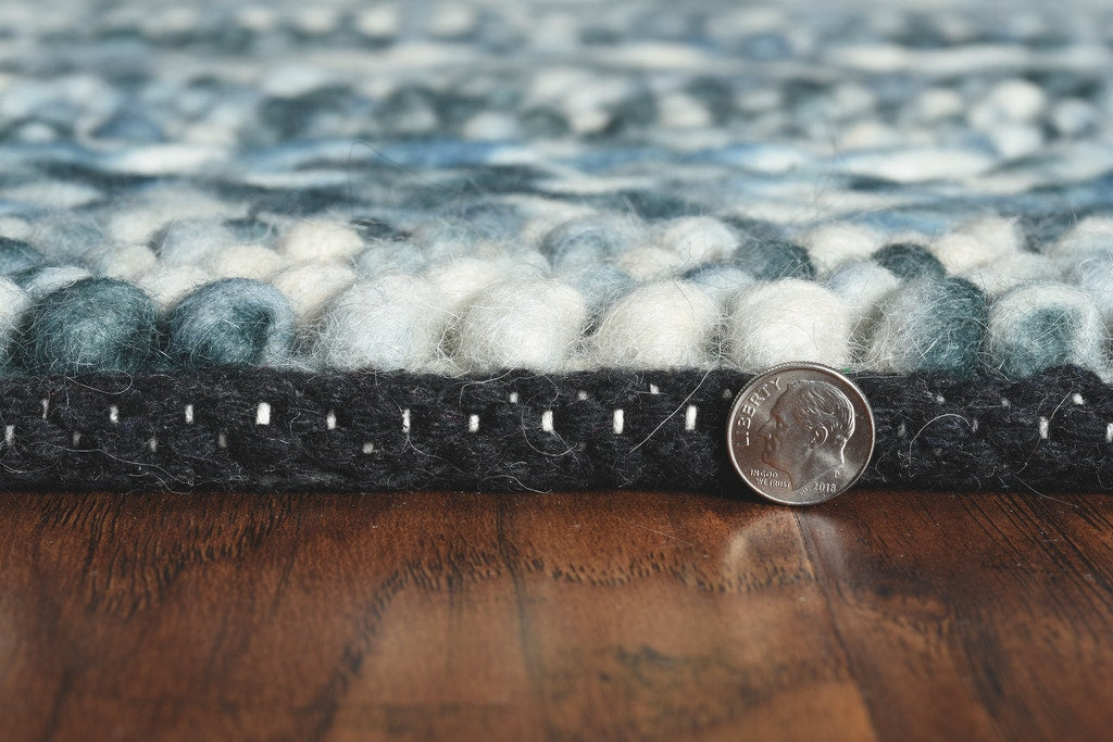 A handwoven 39 X 63 blue wool rug featuring a soft, nobby texture, perfect for contemporary living spaces.