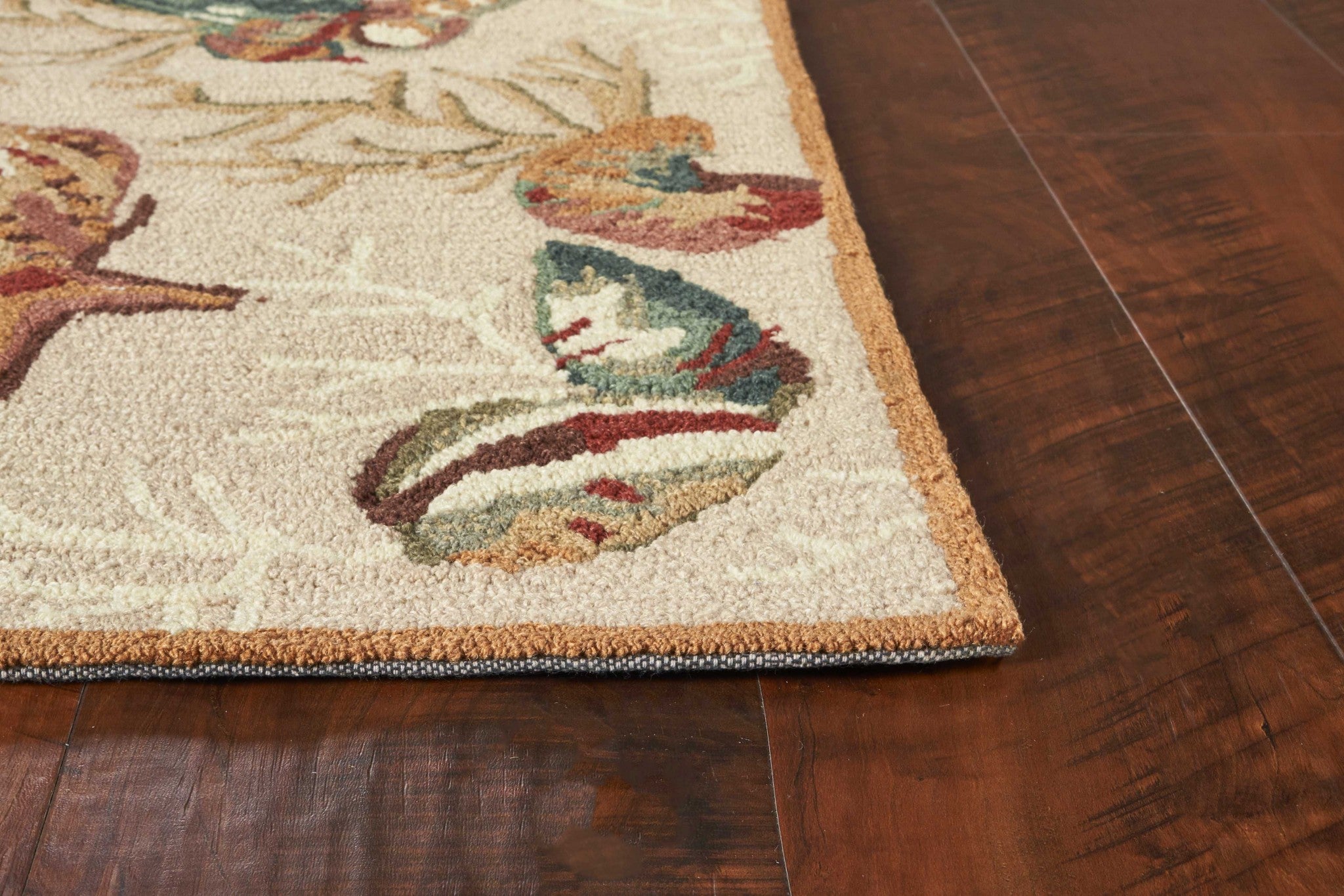 A beautifully designed beige area rug featuring corals and shells, perfect for enhancing home decor.