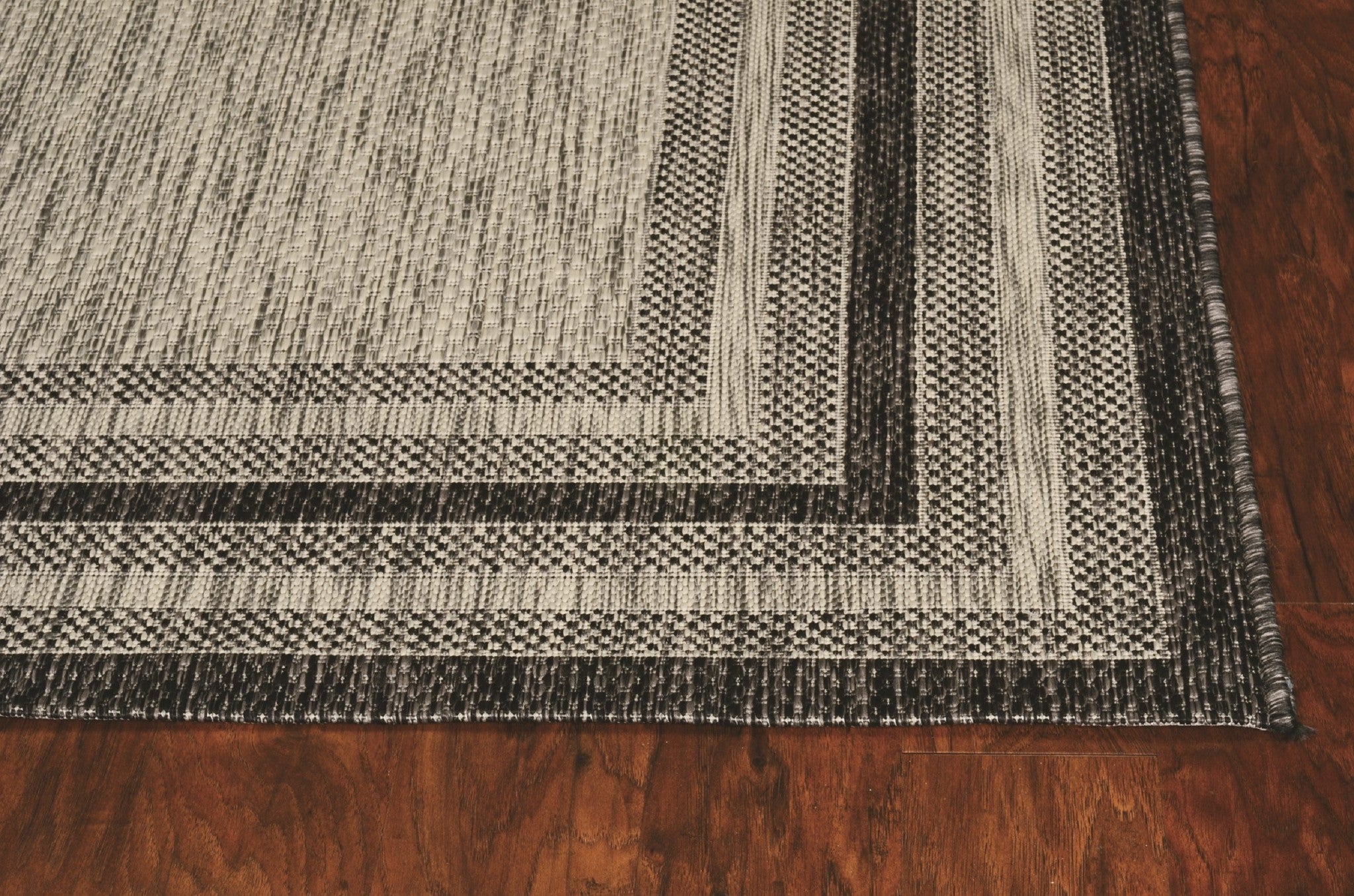 3x5 grey polypropylene area rug with textured design, suitable for indoor and outdoor use.