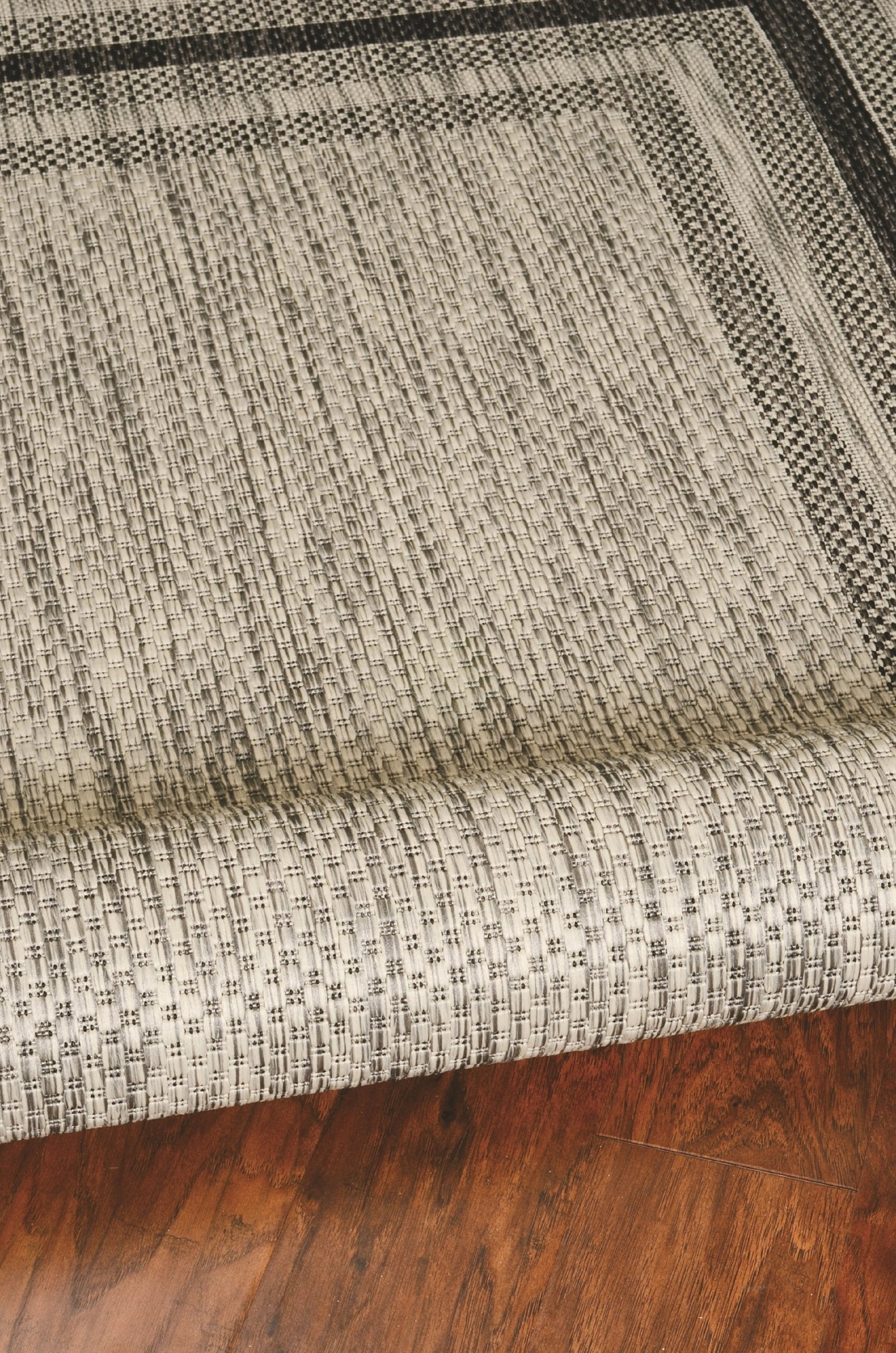 3x5 grey polypropylene area rug with textured design, suitable for indoor and outdoor use.