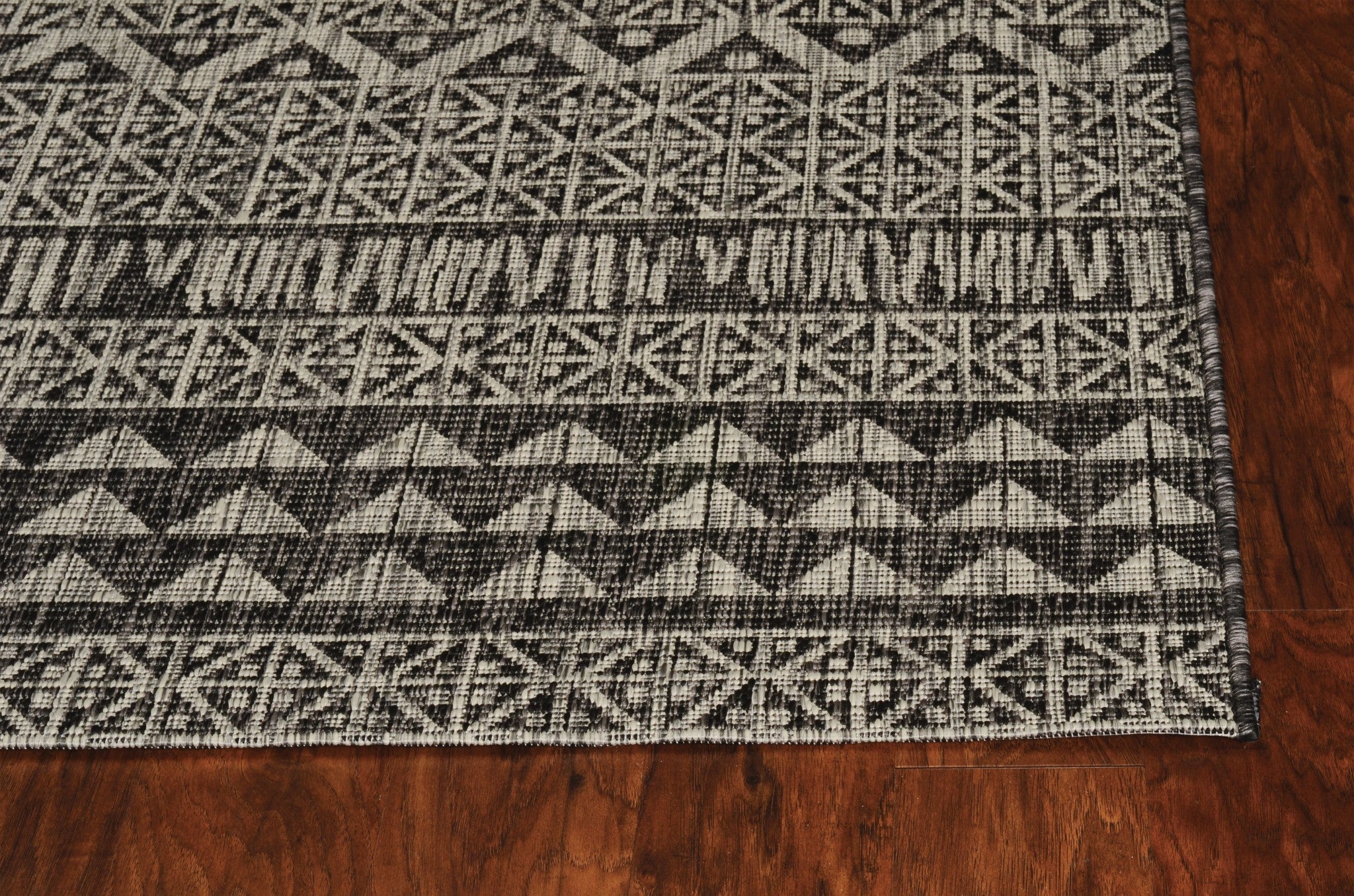 3x4 charcoal tribal indoor/outdoor rug with vibrant patterns, machine-woven in Turkey, suitable for various decor styles.