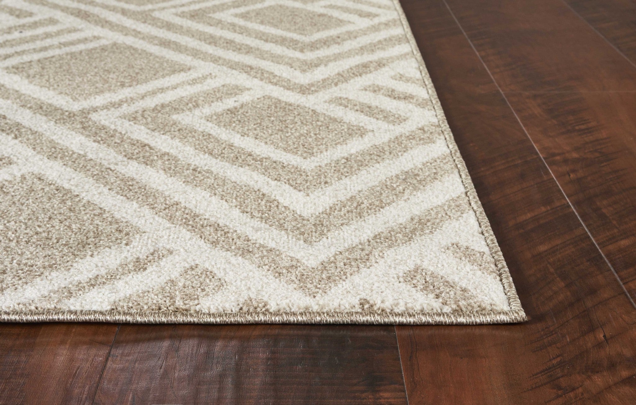 A stylish 3x5 beige machine woven rug with geometric patterns, perfect for indoor and outdoor use.