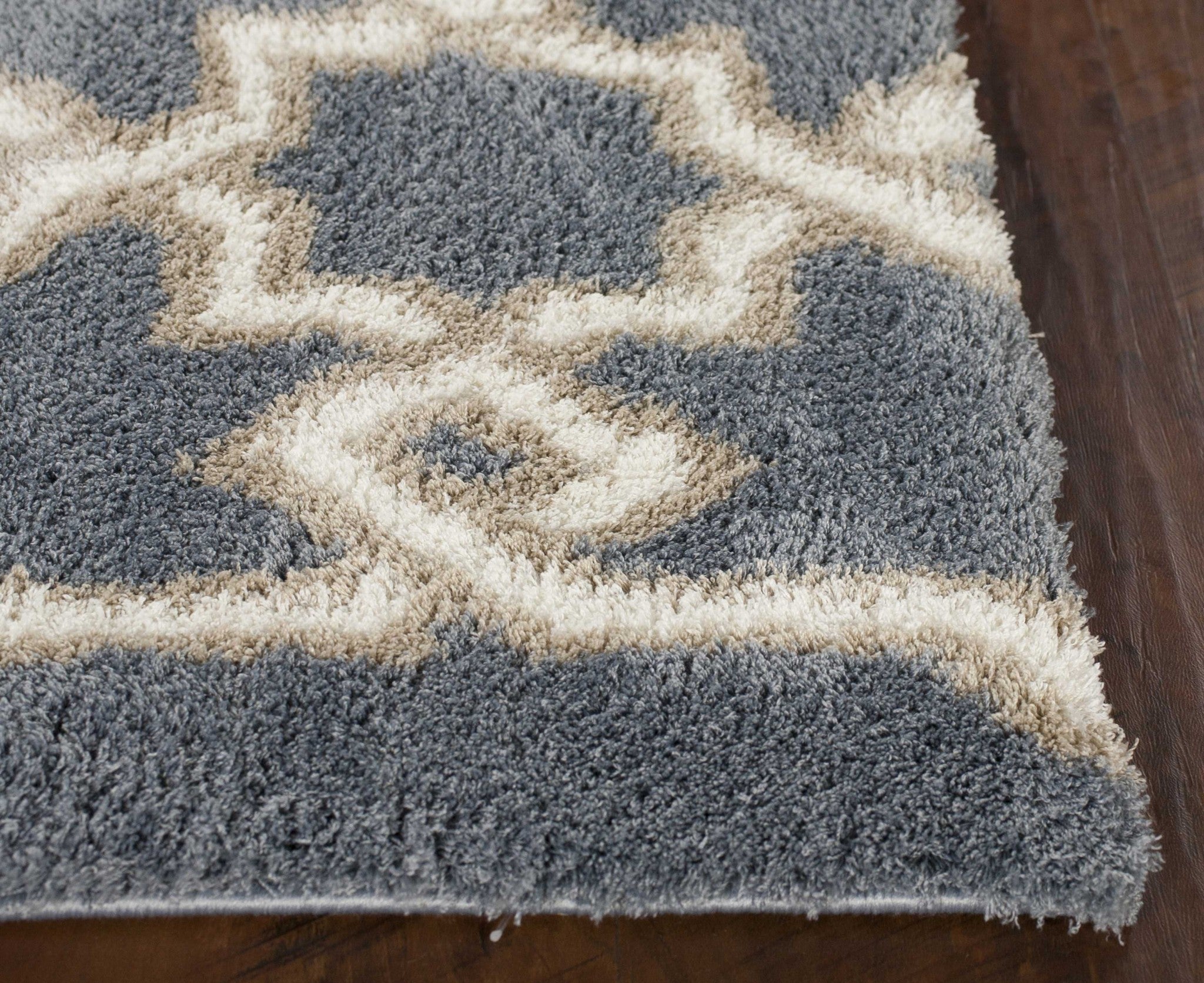 Slate blue geometric machine woven microfiber indoor rug, showcasing a modern design and soft texture, perfect for enhancing home interiors.