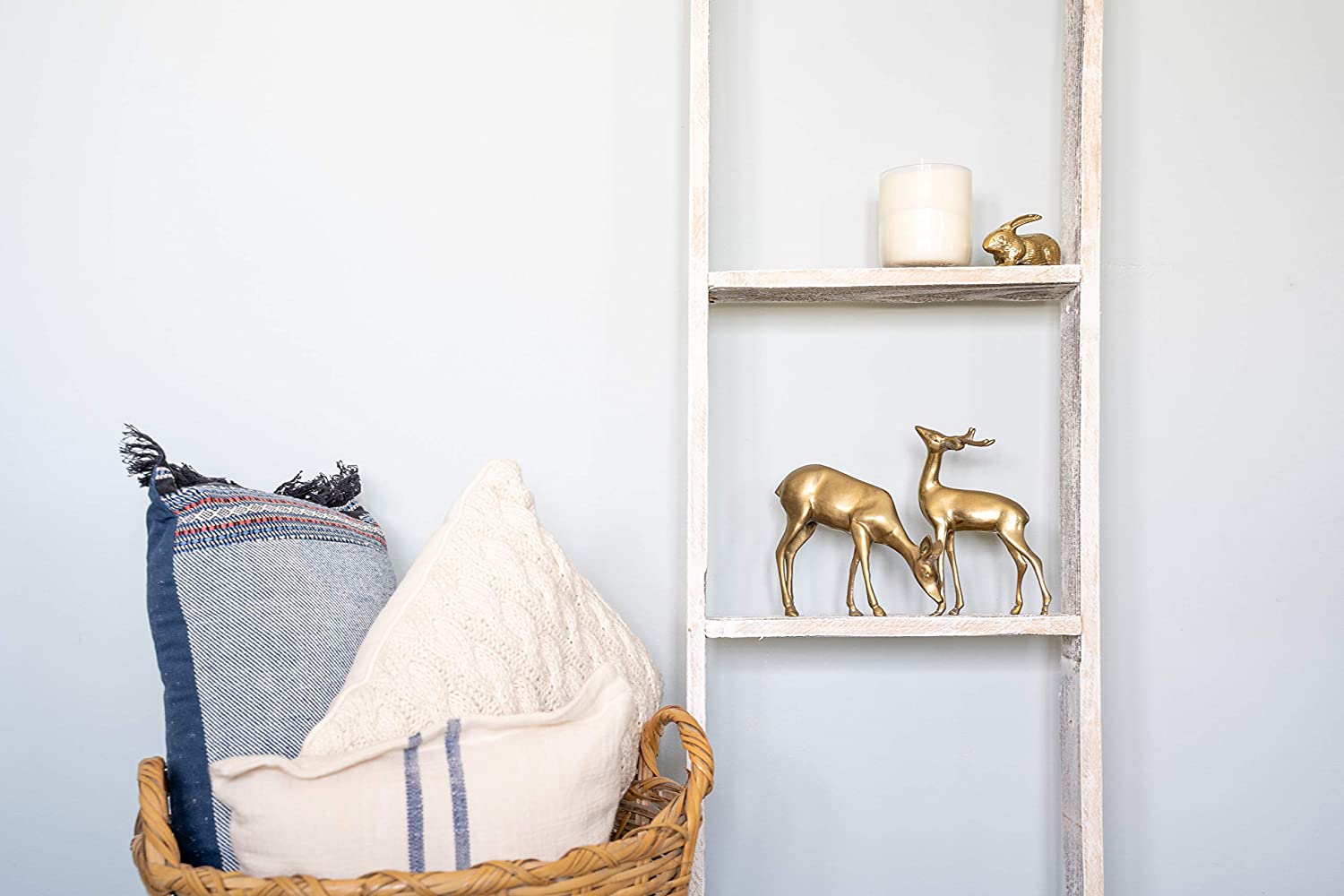 A rustic white wood ladder shelf with four steps, showcasing its unique handmade craftsmanship and reclaimed wood design.