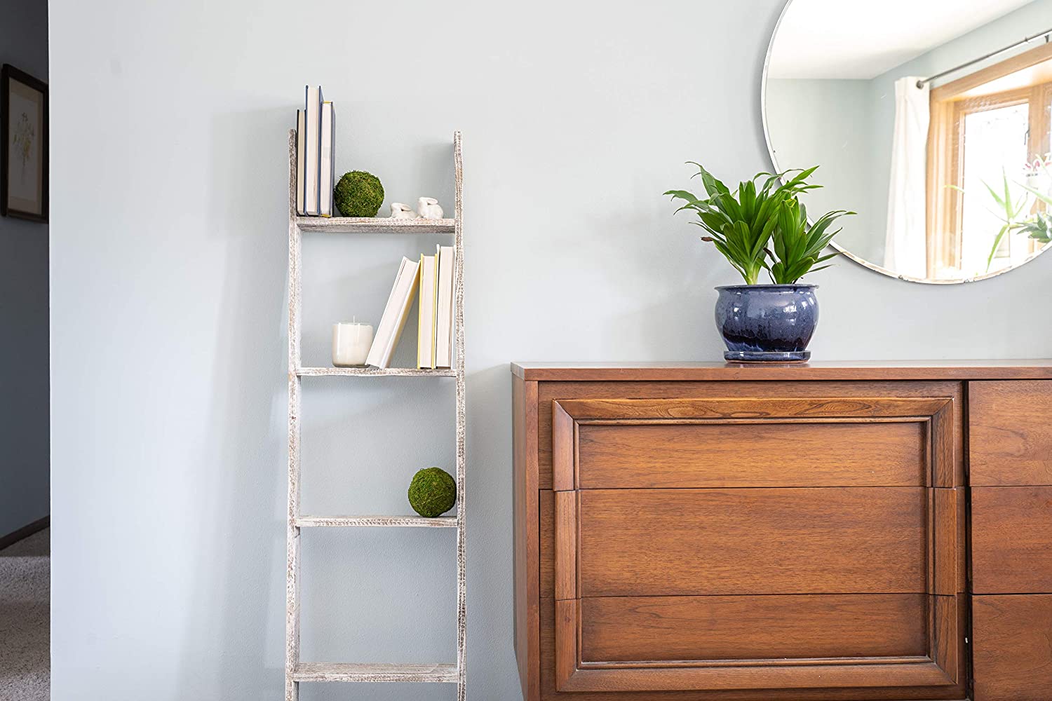 A rustic white wood ladder shelf with four steps, showcasing its unique handmade craftsmanship and reclaimed wood design.