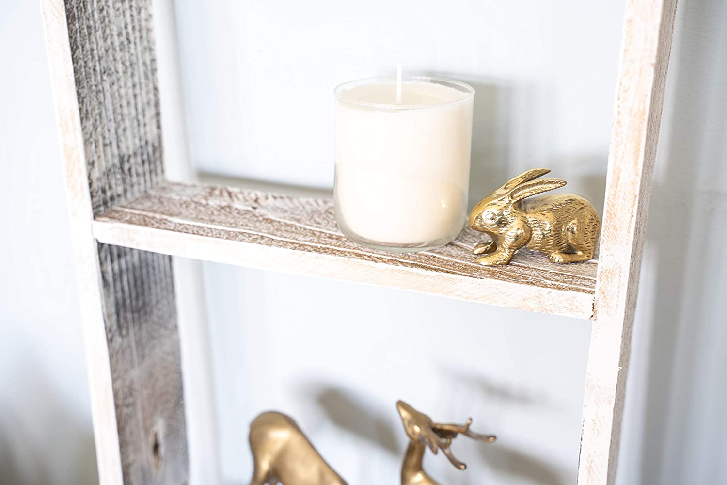 A rustic white wood ladder shelf with four steps, showcasing its unique handmade craftsmanship and reclaimed wood design.