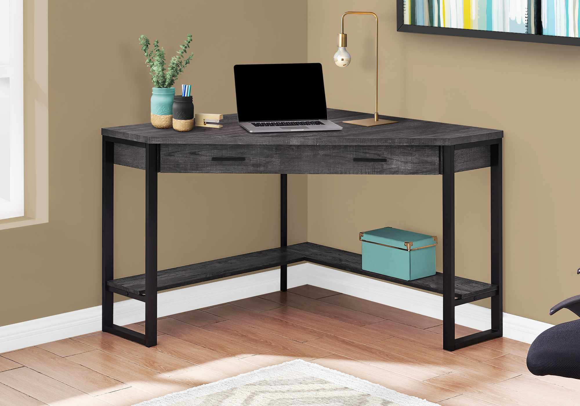 A stylish black reclaimed wood corner computer desk with a long drawer, designed for small spaces.