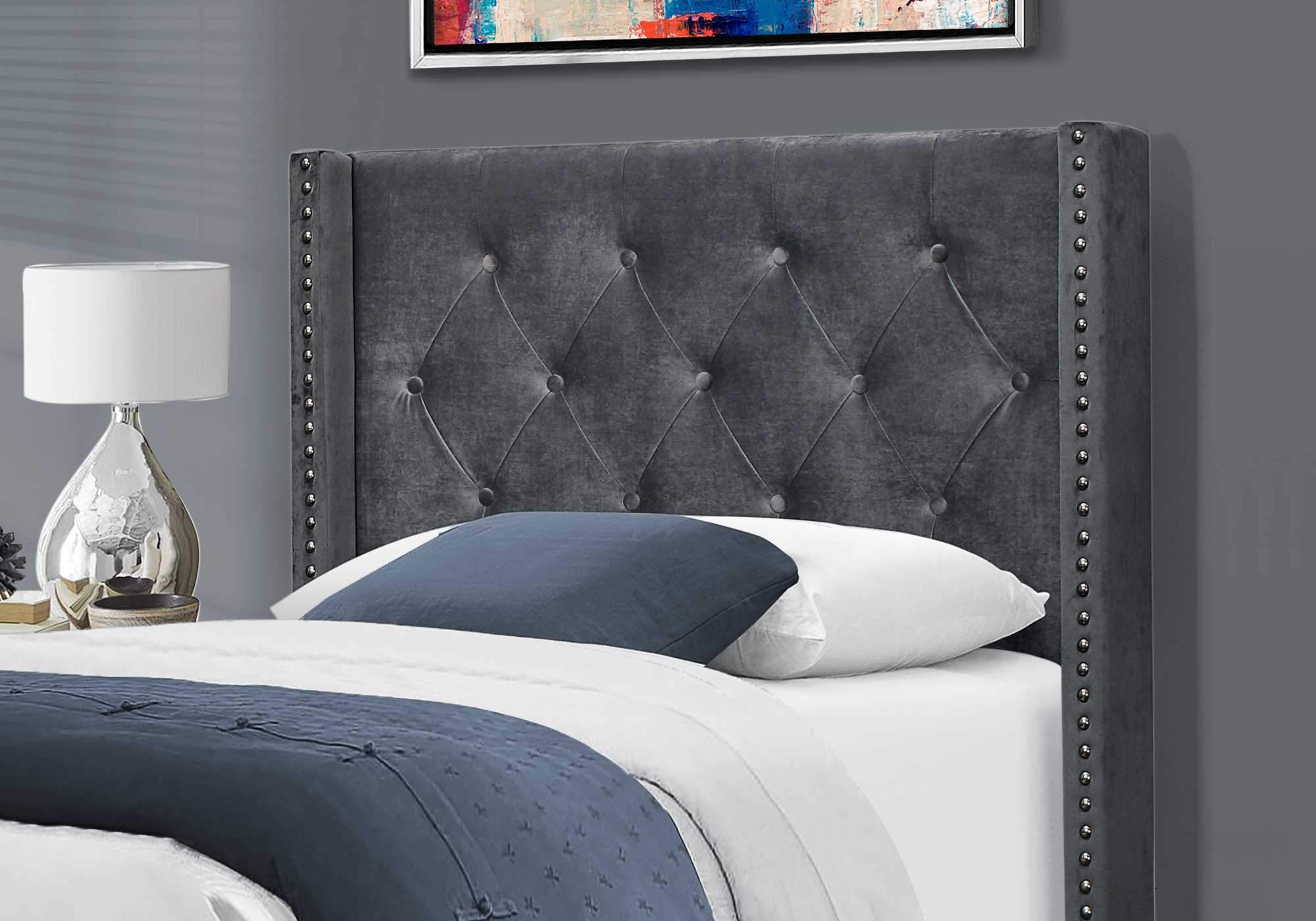 Luxurious twin size bed frame in dark grey velvet with chrome nail head trim and wingback headboard.